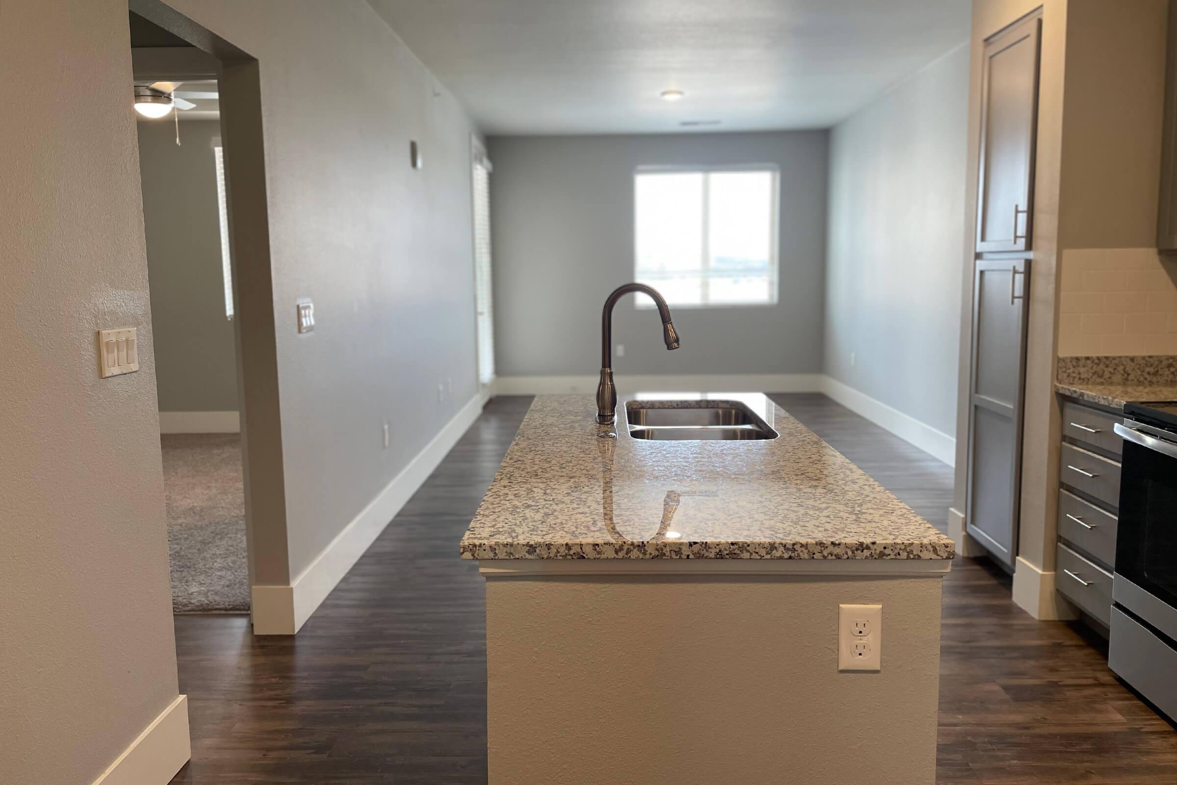 a kitchen with a sink and a mirror