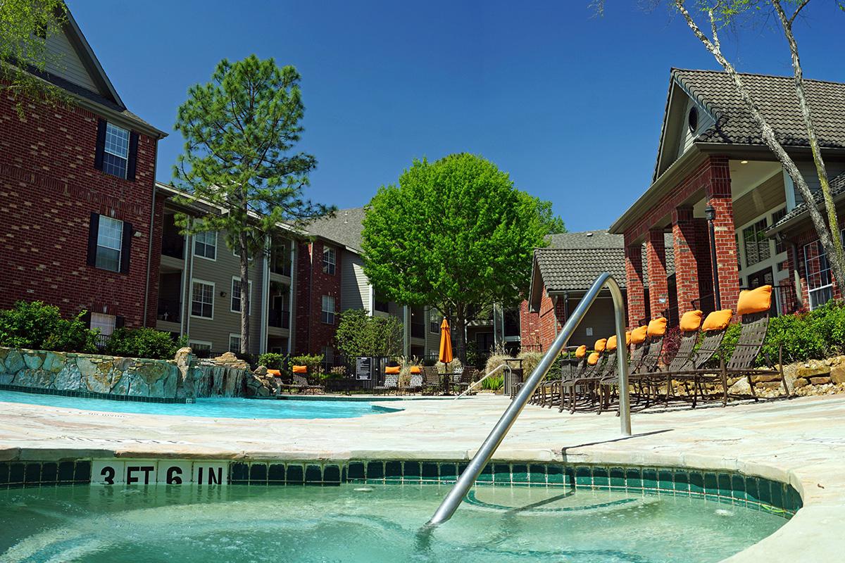 a house with a pool in front of a building
