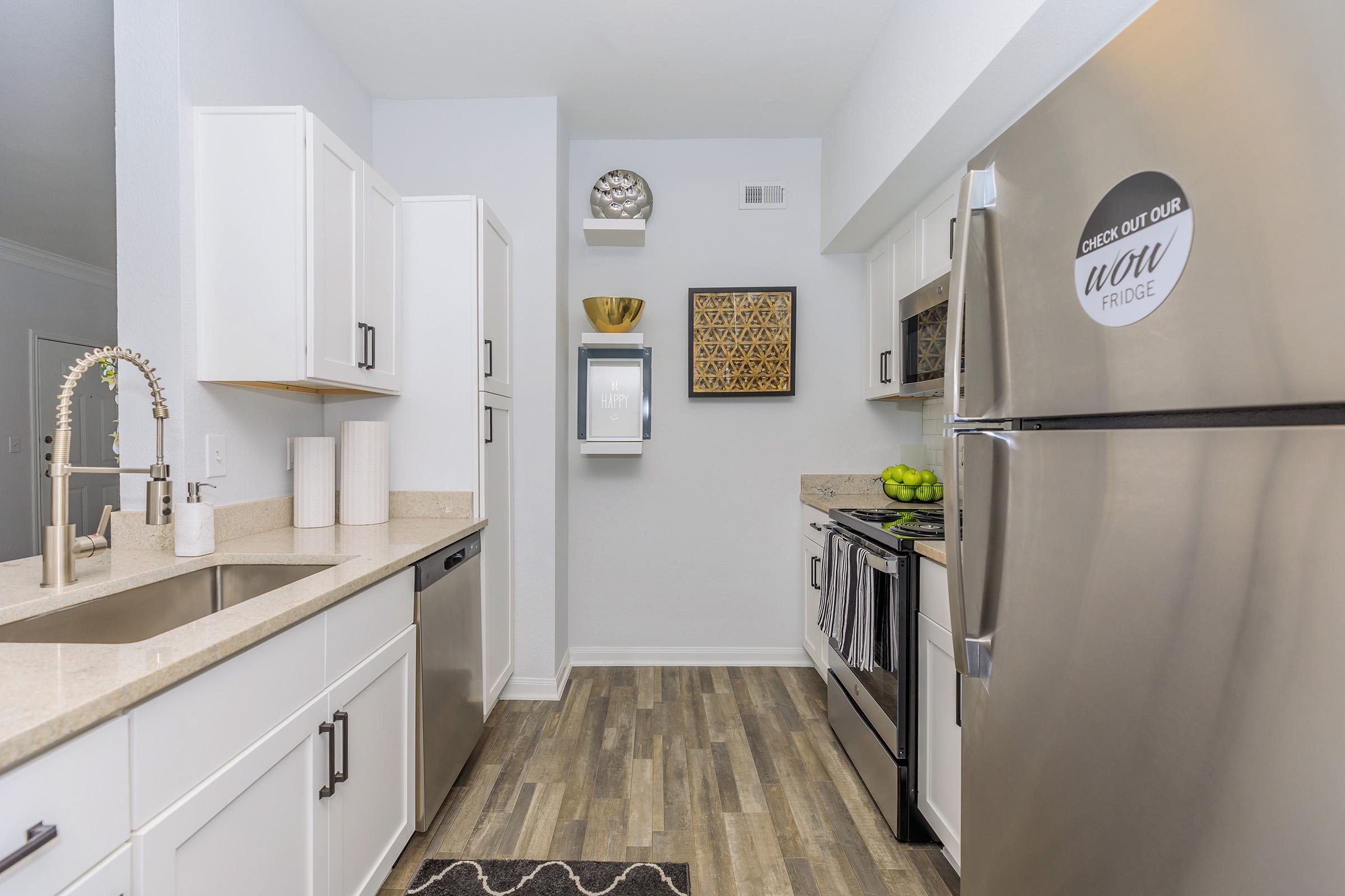 a kitchen with a sink and a mirror