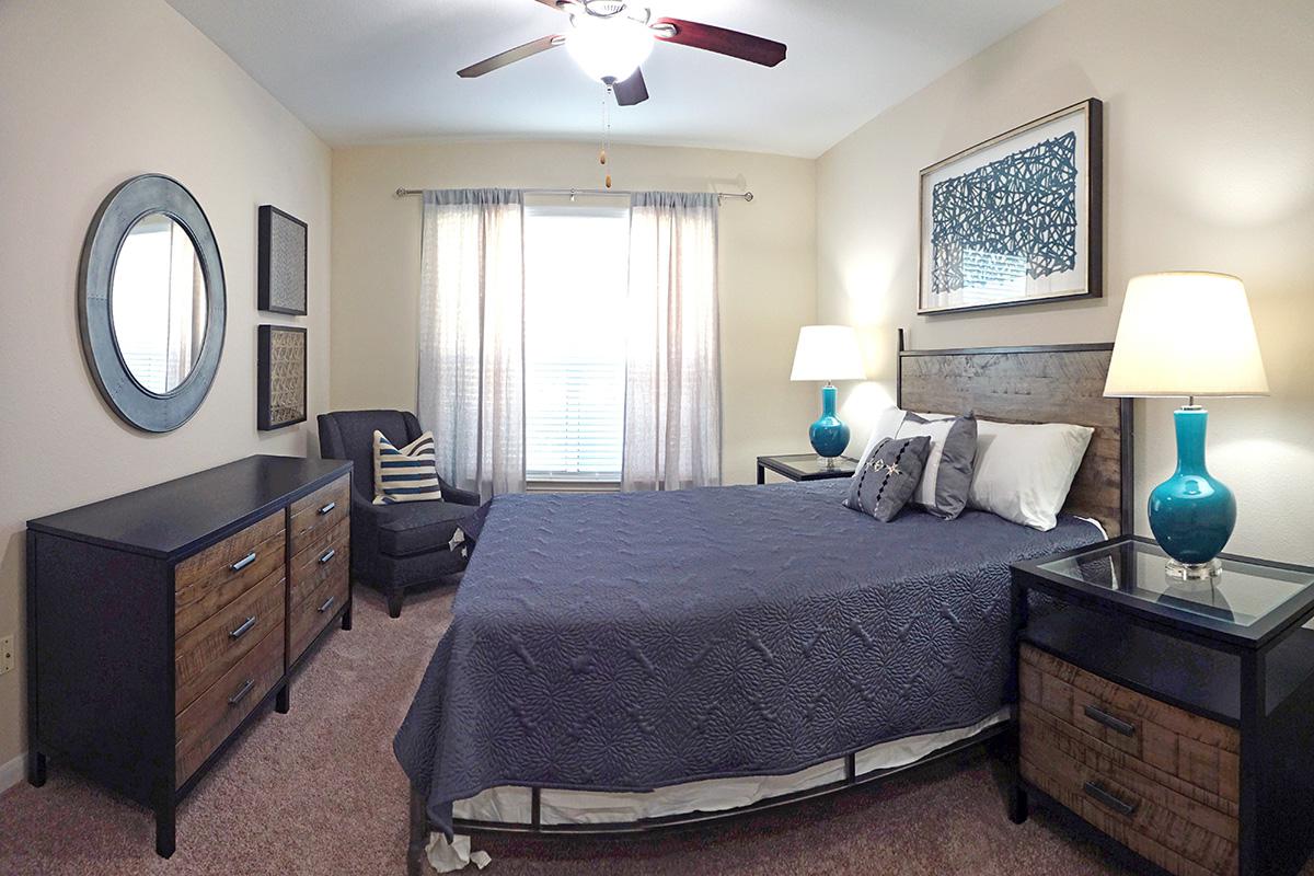 a bedroom with a bed and desk in a room