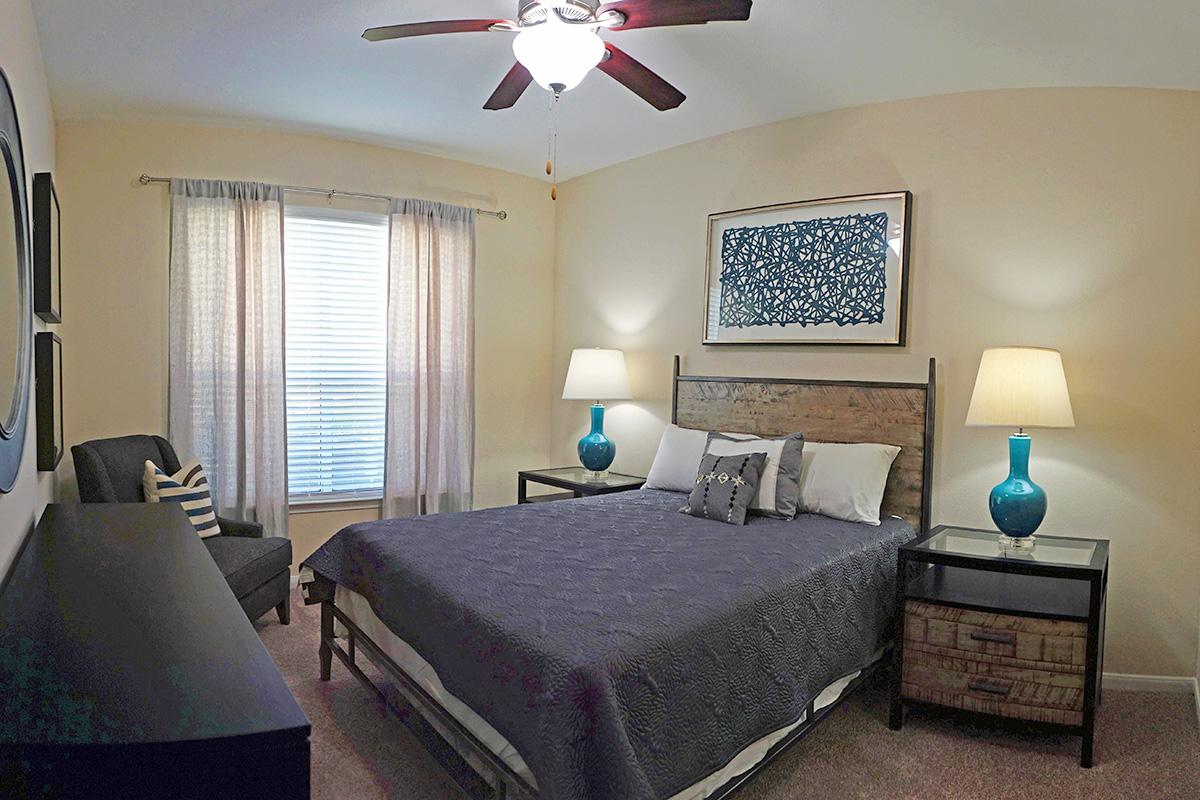 a bedroom with a bed and desk in a room