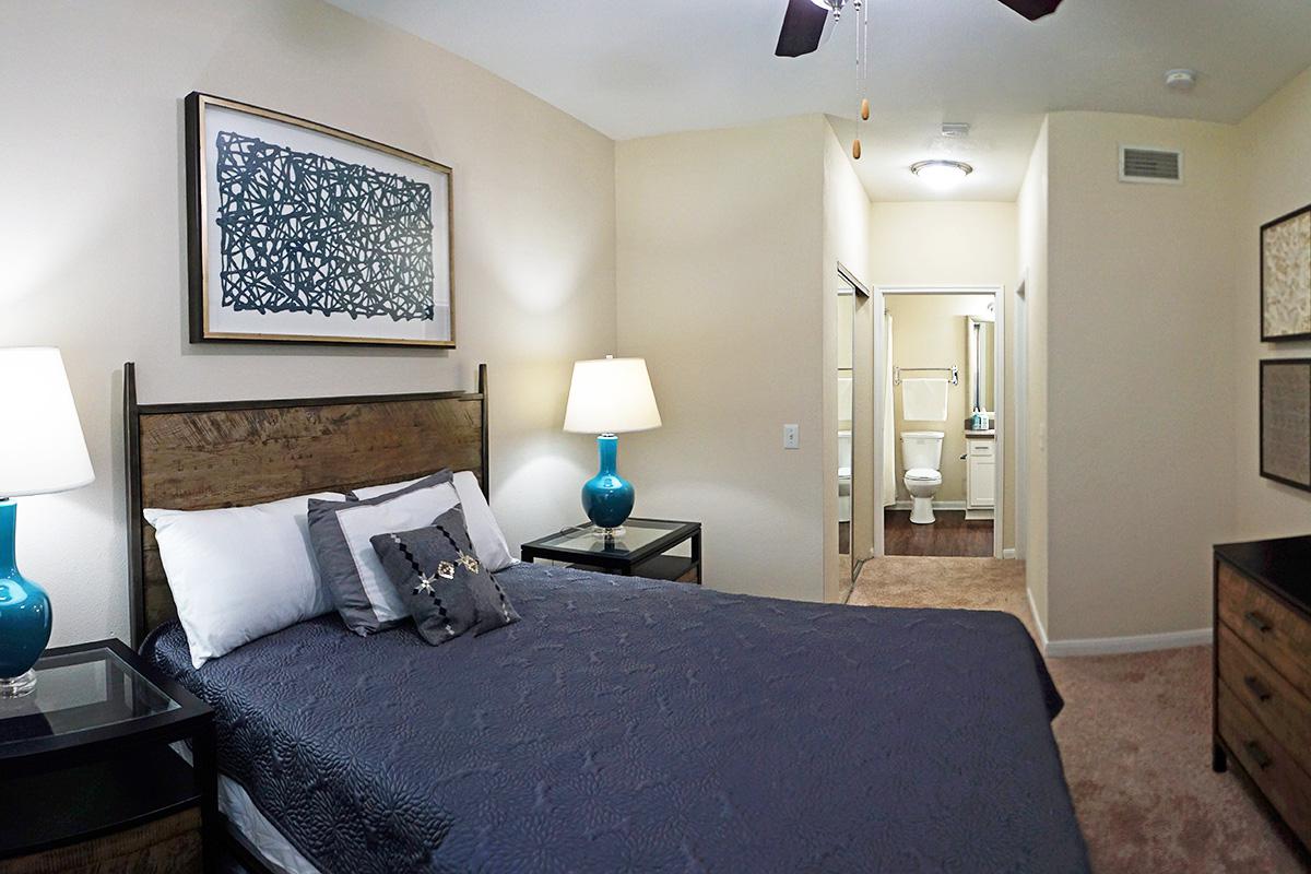 a bedroom with a bed and desk in a room
