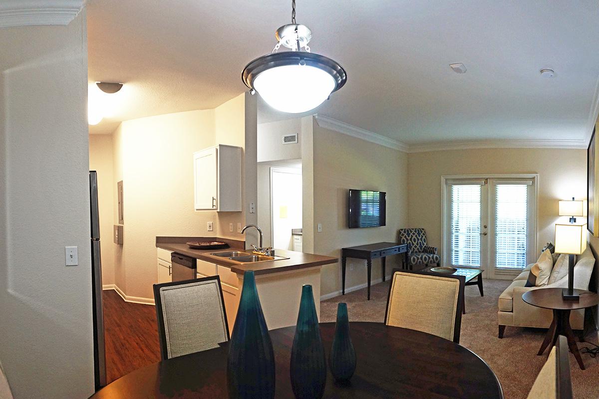 a view of a living room filled with furniture and a table