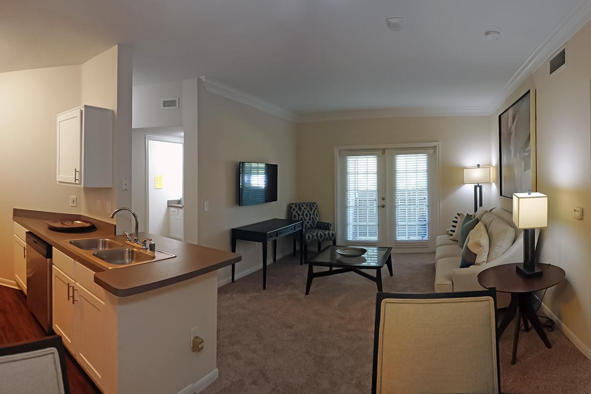 a bedroom with a bed and desk in a small room
