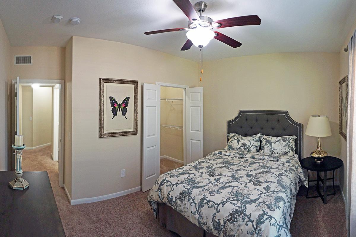 a bedroom with a bed and desk in a small room