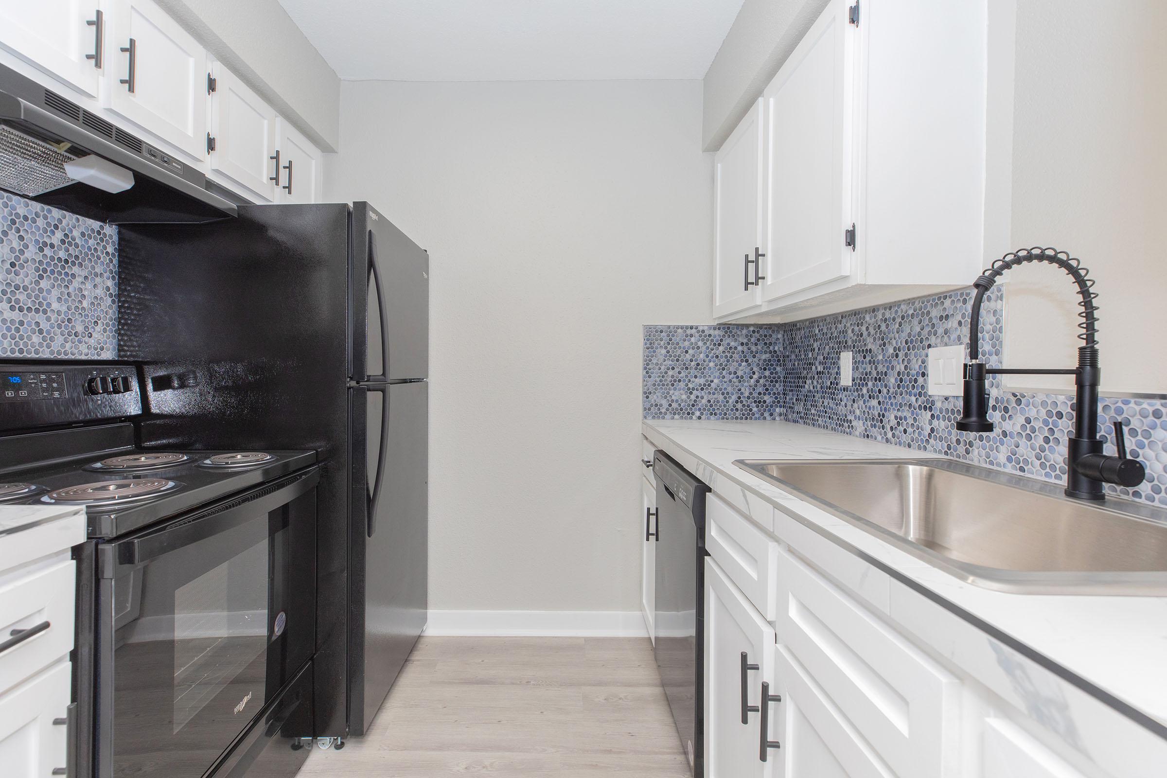 a kitchen with a stove sink and refrigerator