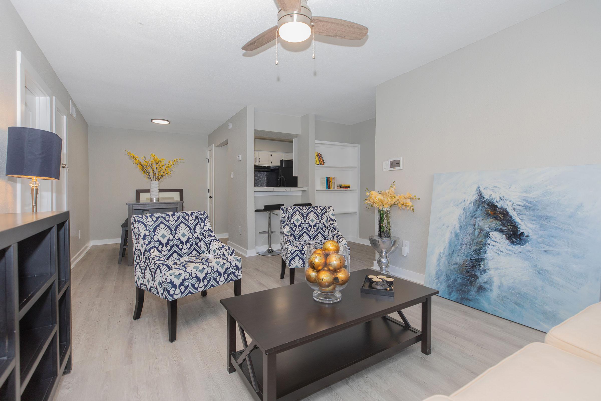 a living room filled with furniture and a table