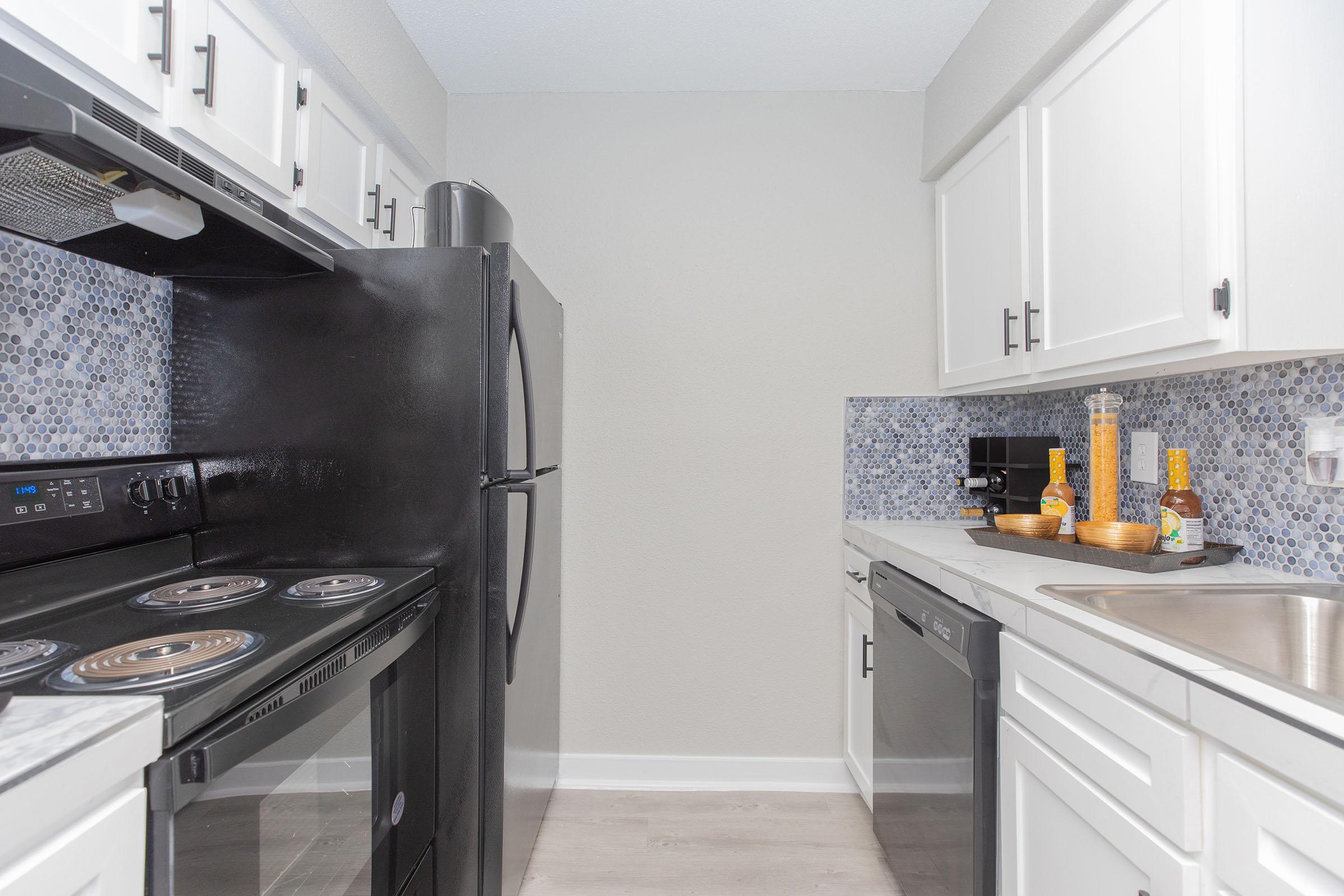 a stove top oven sitting inside of a kitchen