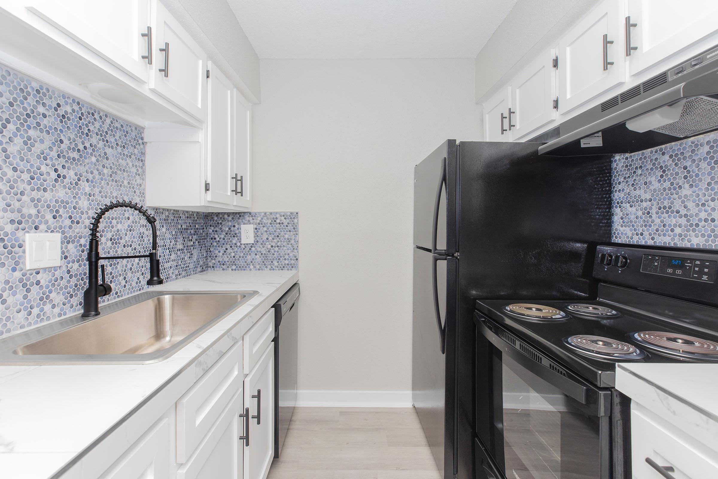 a stove top oven sitting inside of a kitchen