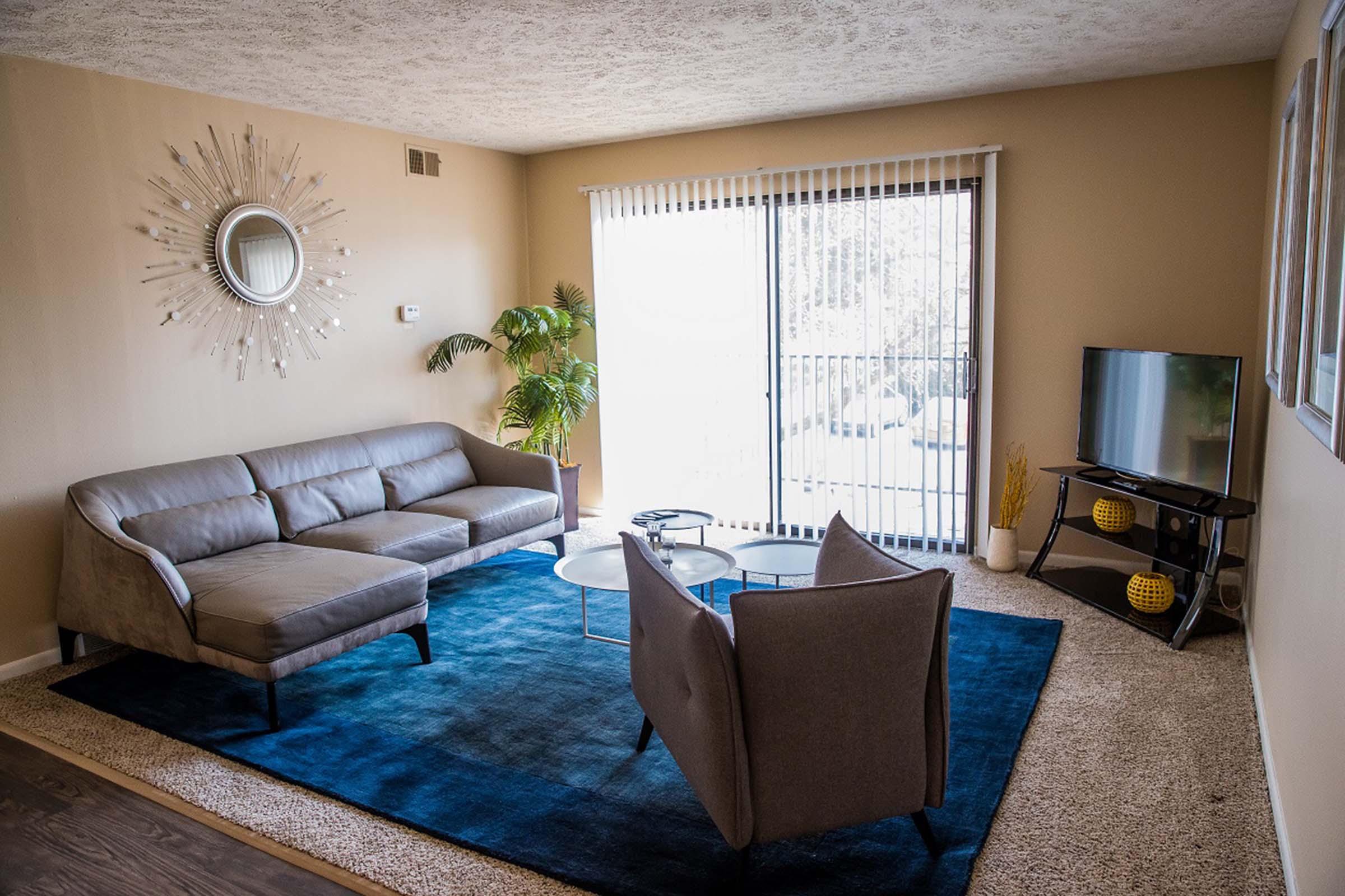 a living room filled with furniture and a large window