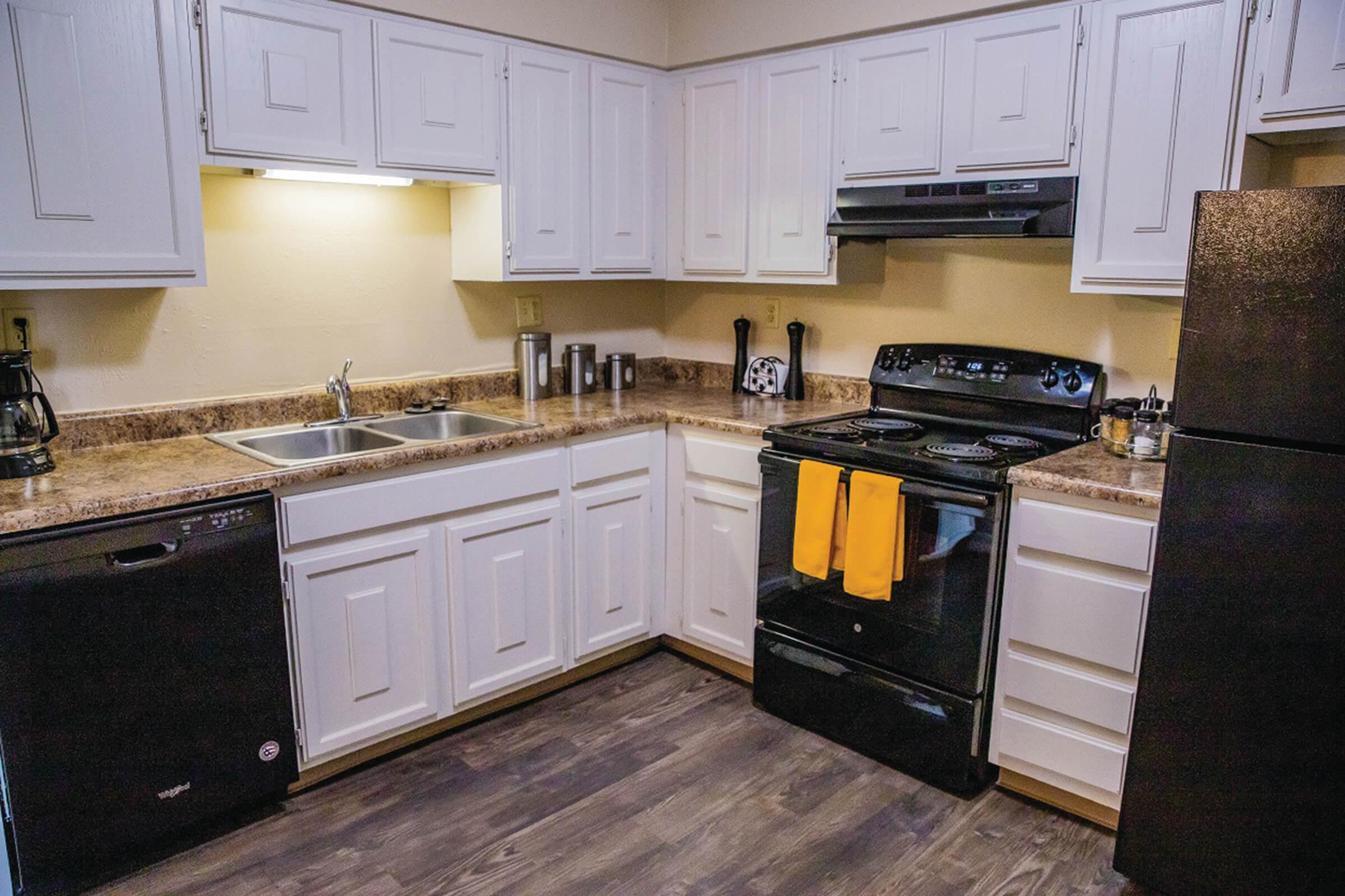 a stove top oven sitting inside of a kitchen