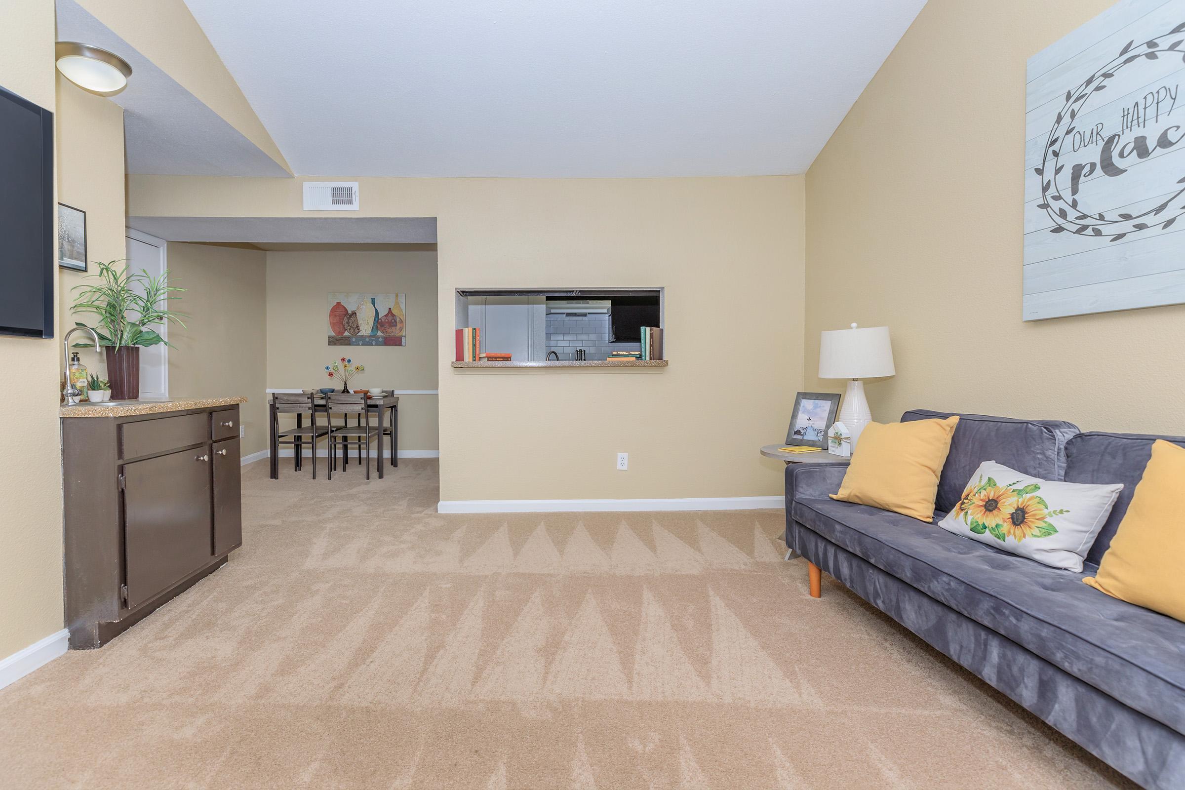 a living room filled with furniture and a flat screen tv