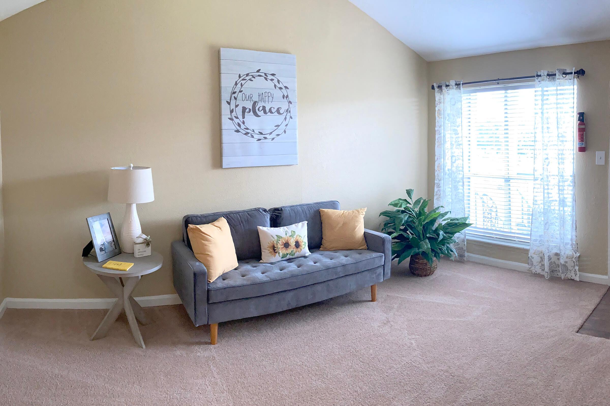 a living room filled with furniture and a large window