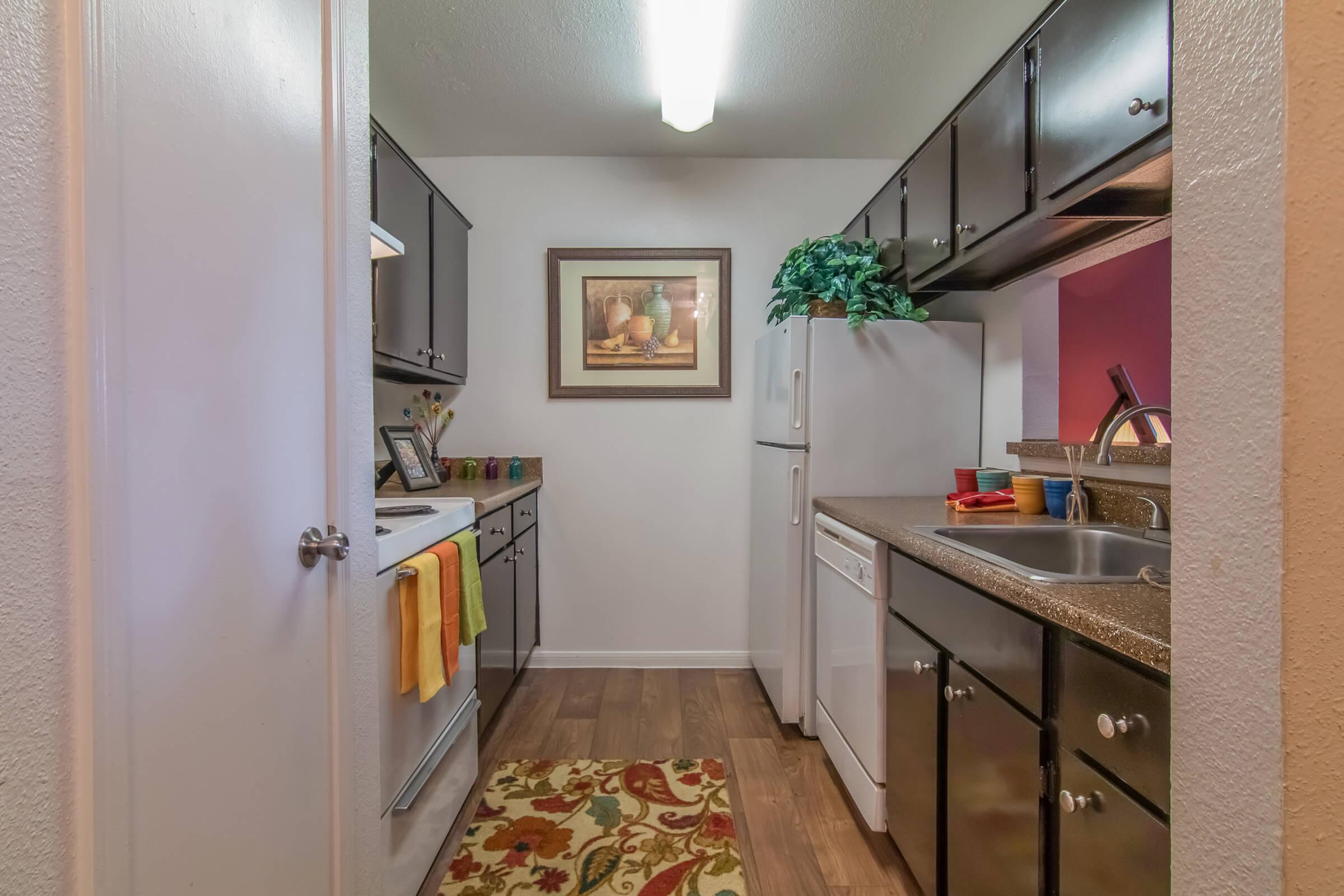 a kitchen with a sink and a mirror