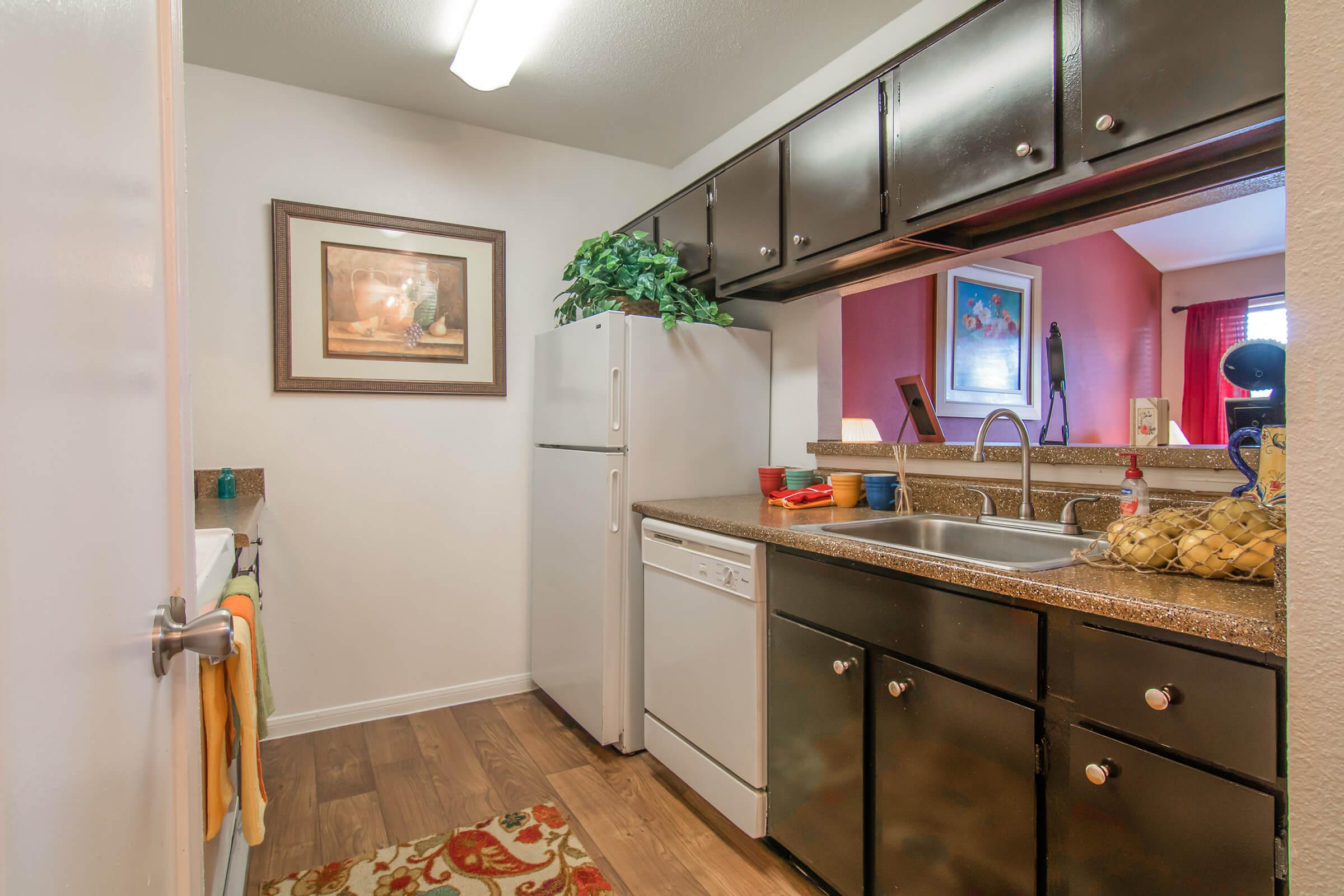 a kitchen with a sink and a mirror