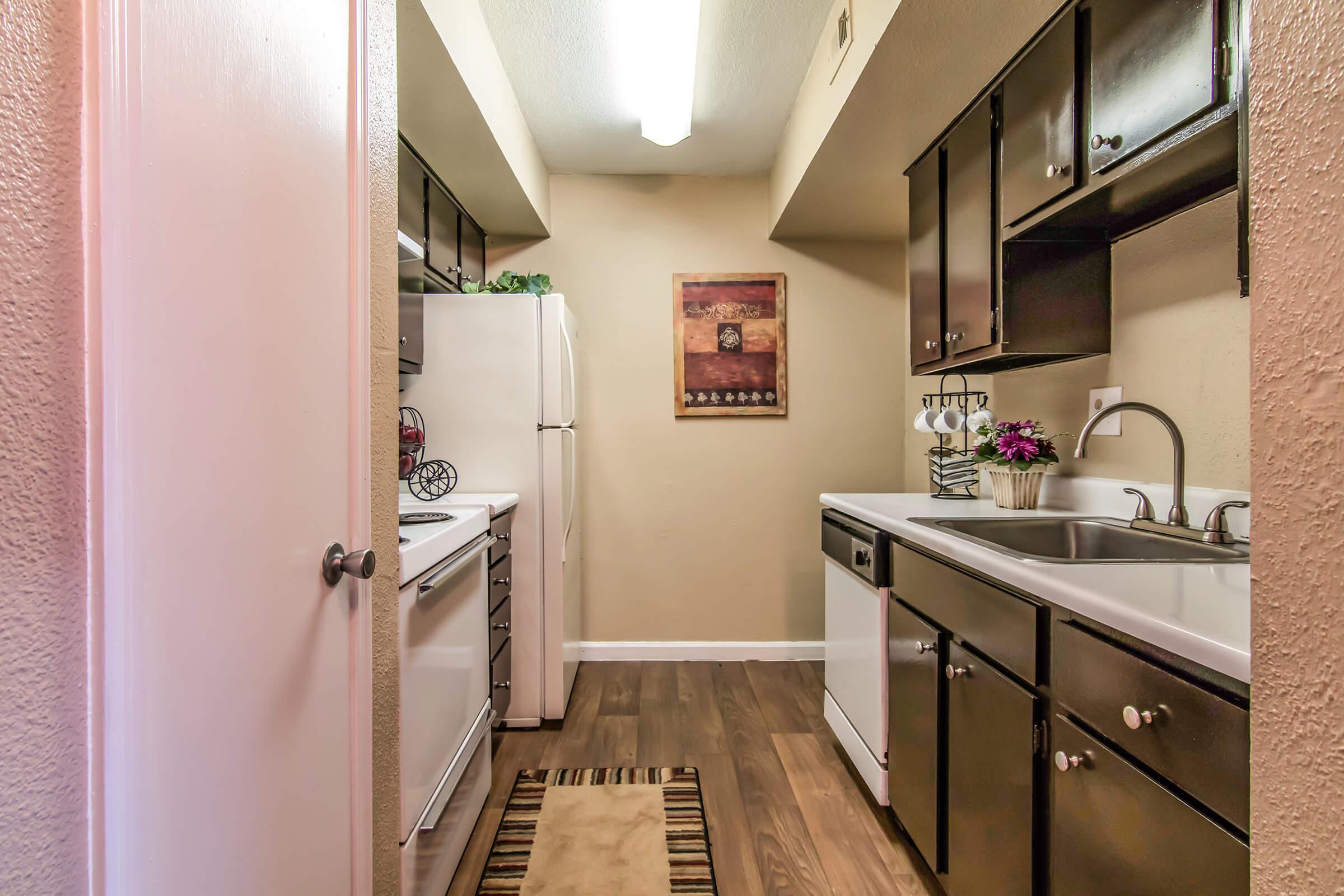 a kitchen with a sink and a mirror