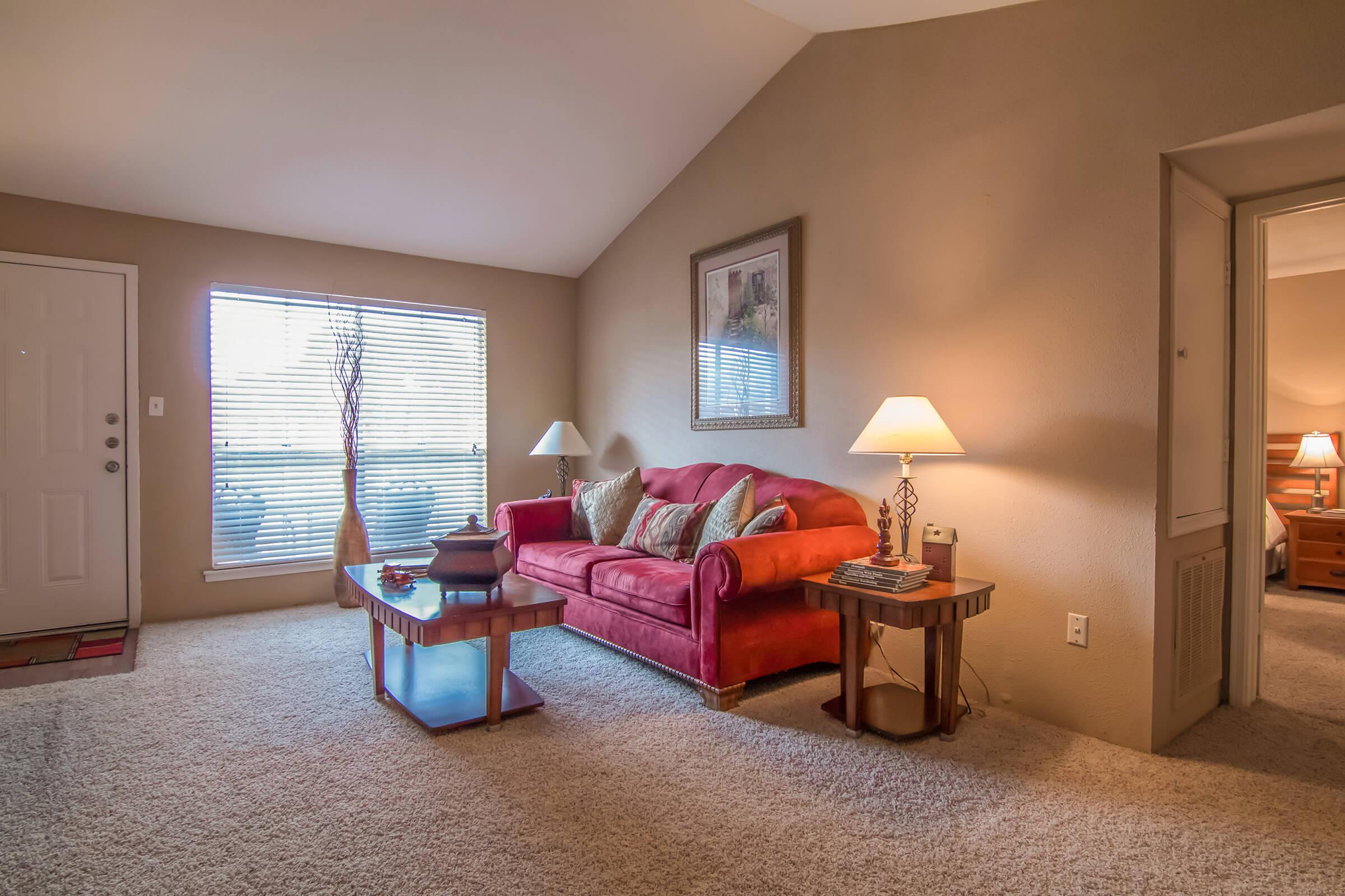 a living room filled with furniture and a large window