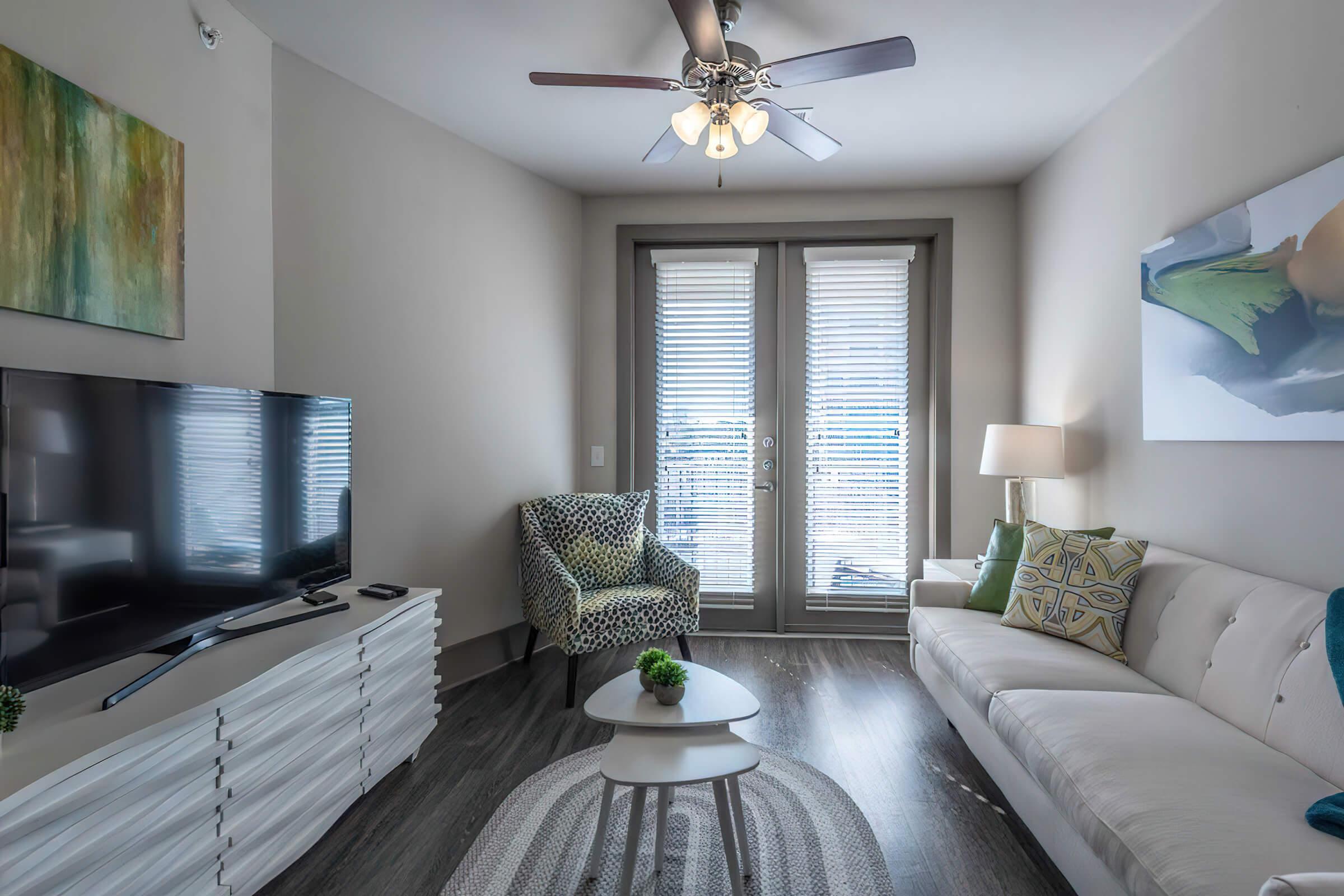 a living room with a bed and a window