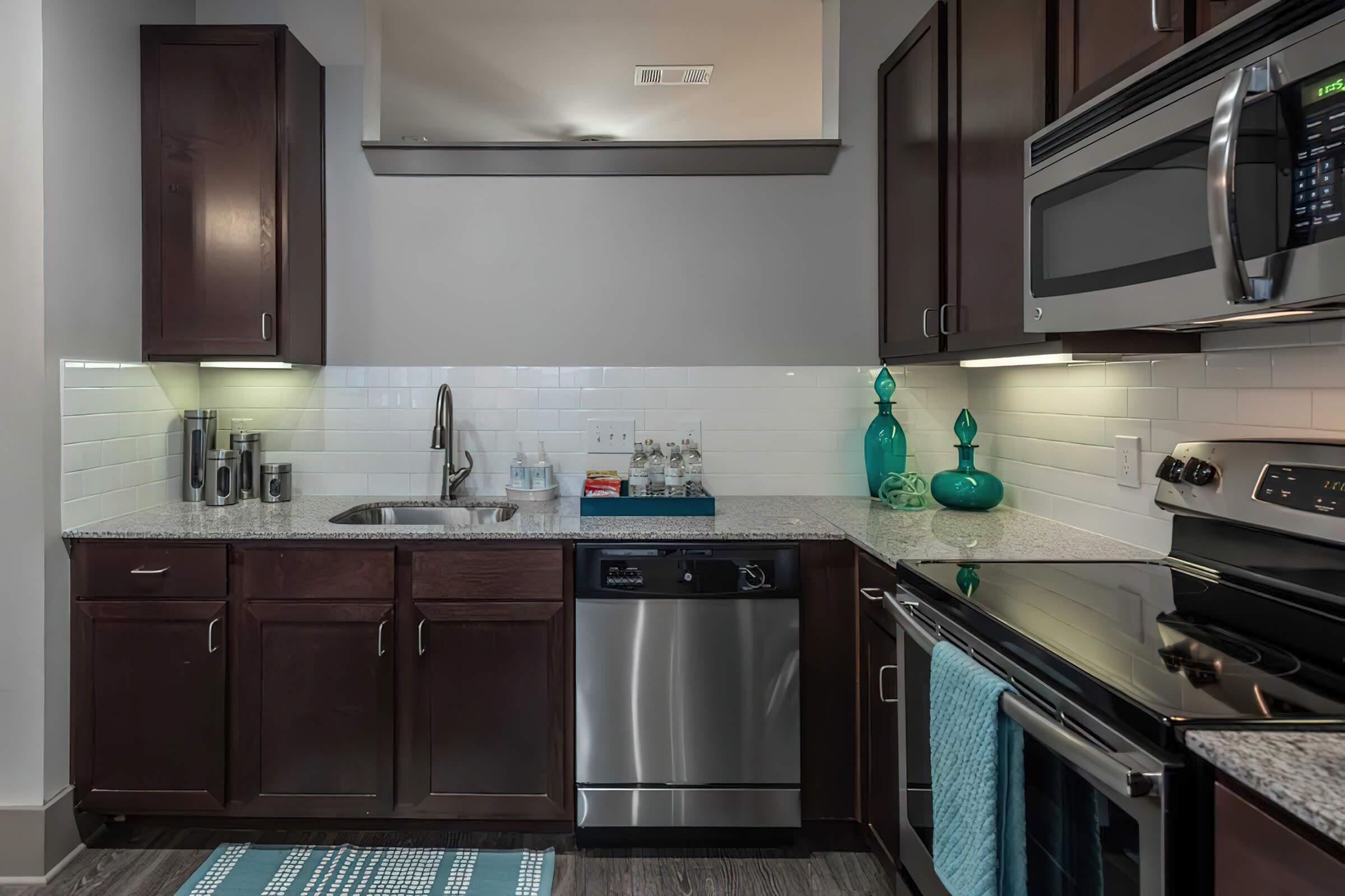 a kitchen with a stove a sink and a microwave