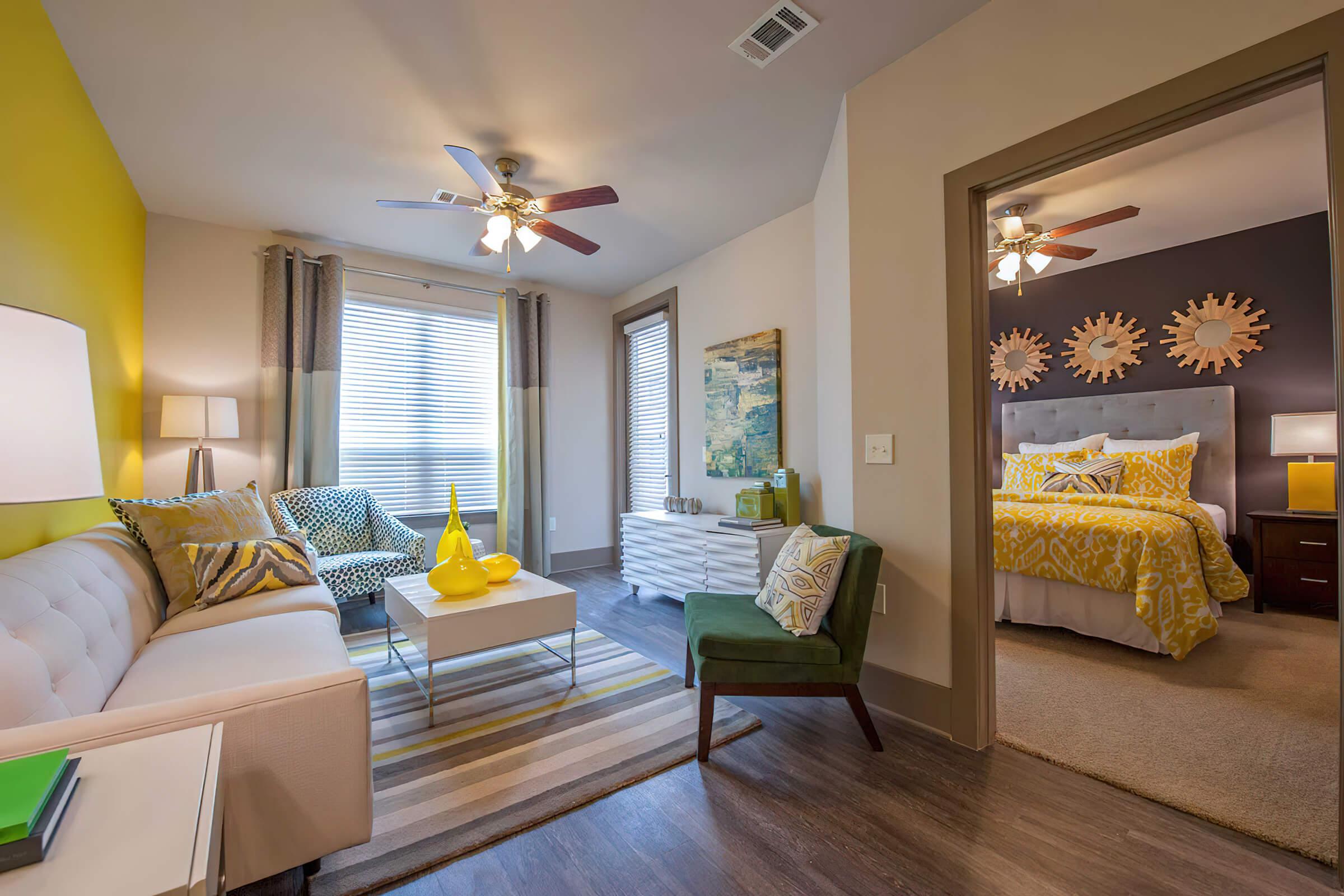 a living room filled with furniture and a bed