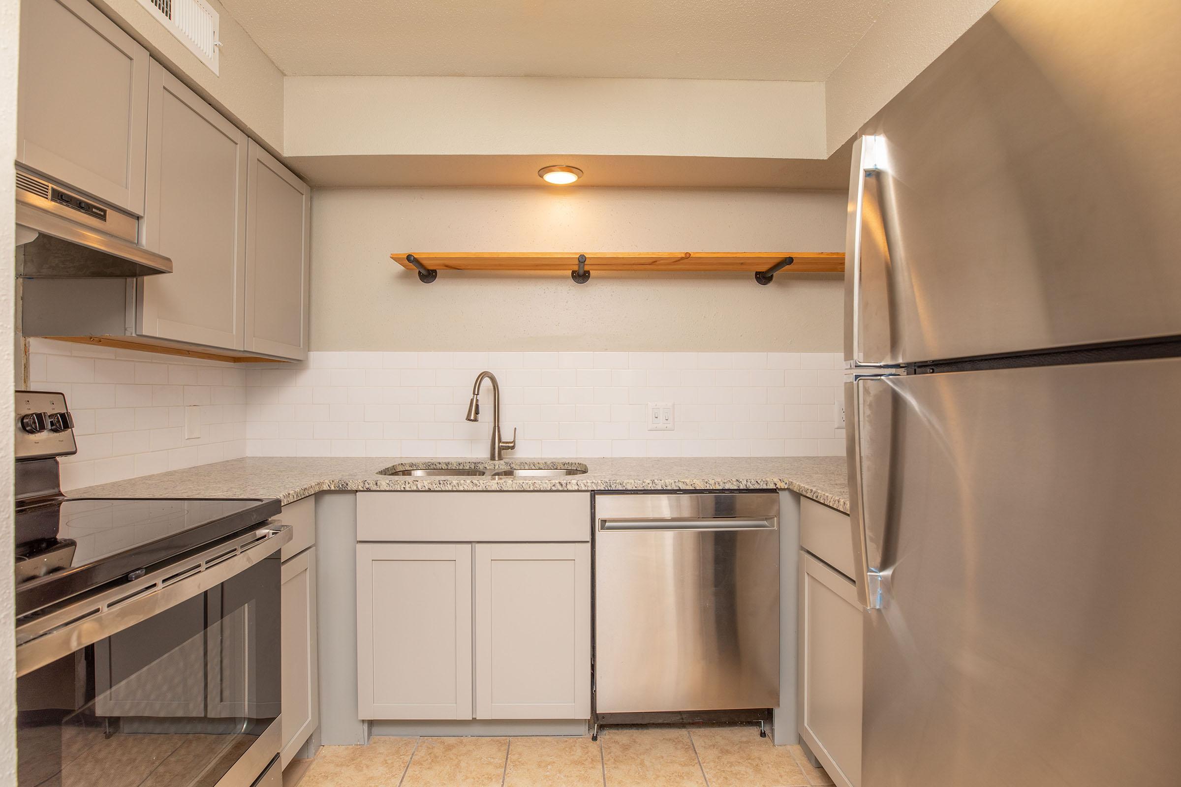 a kitchen with a sink and a refrigerator