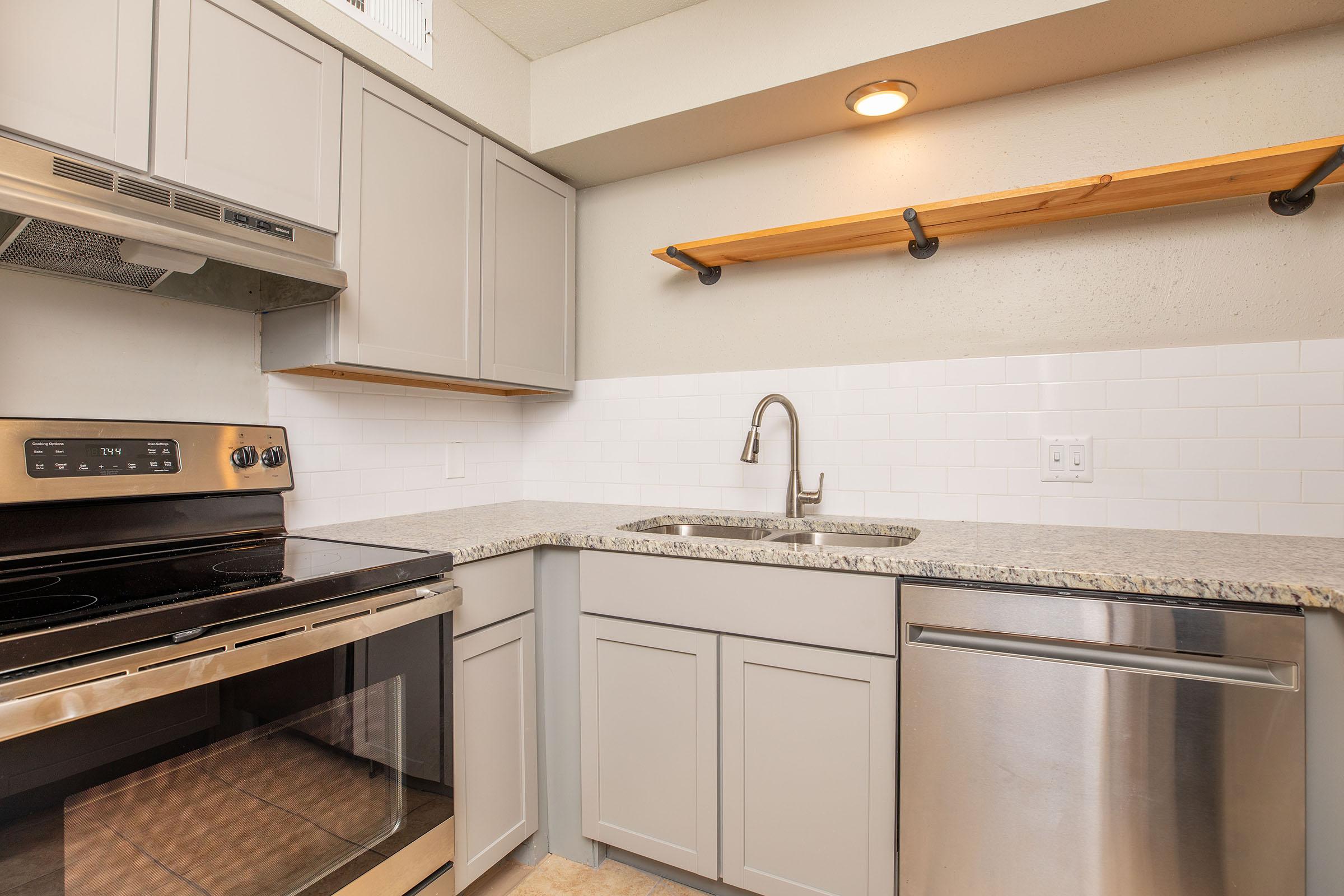 a stove top oven sitting inside of a kitchen