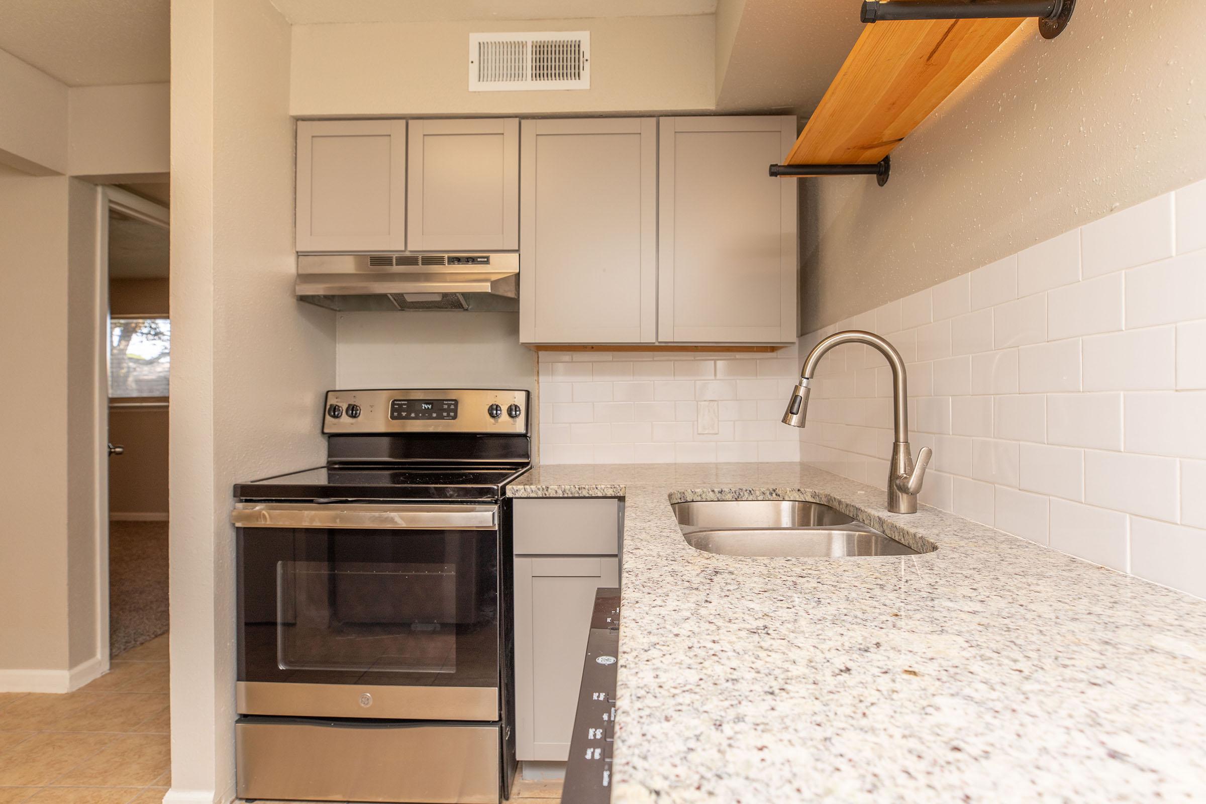 a stove top oven sitting inside of a kitchen