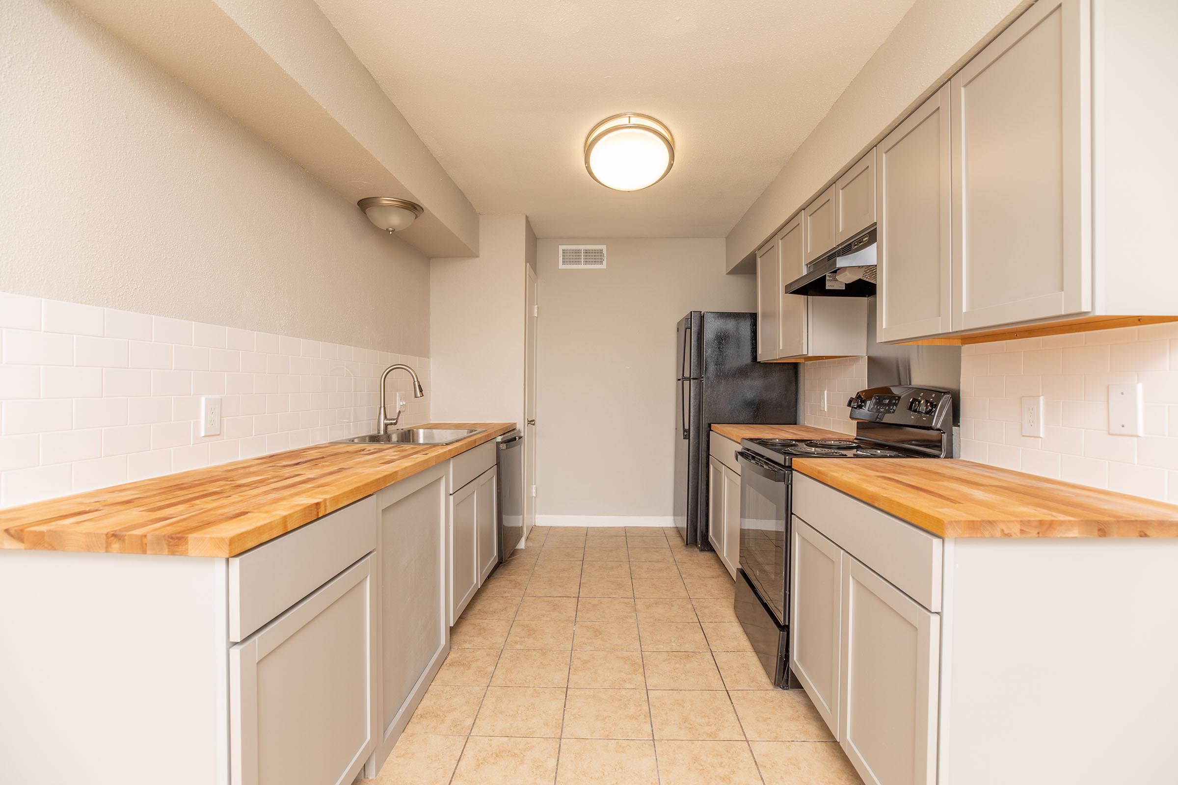 a kitchen with a tile floor