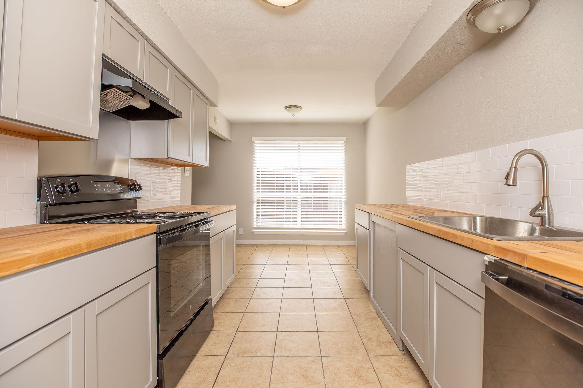 a kitchen with a tile floor