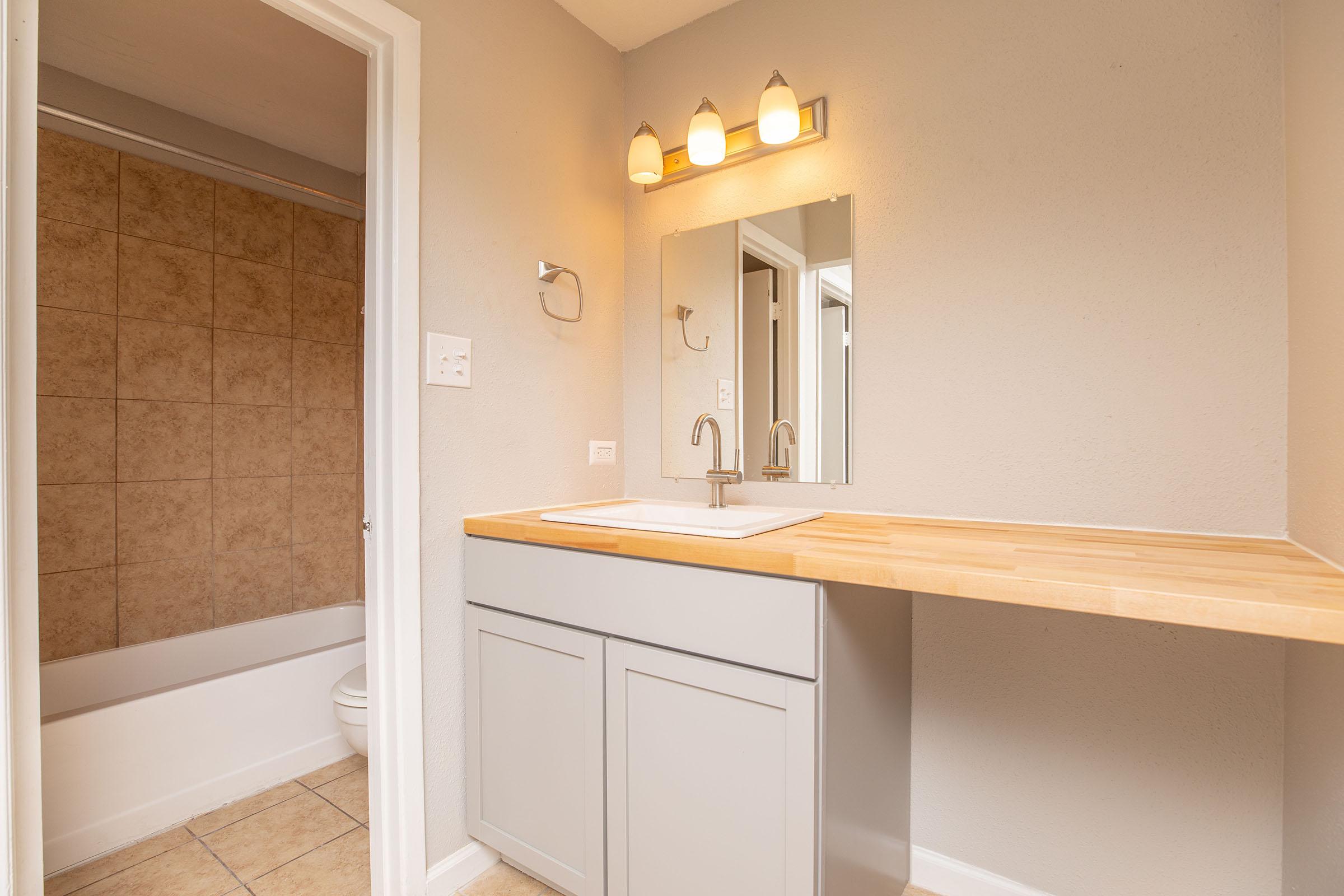 a kitchen with a sink and a mirror