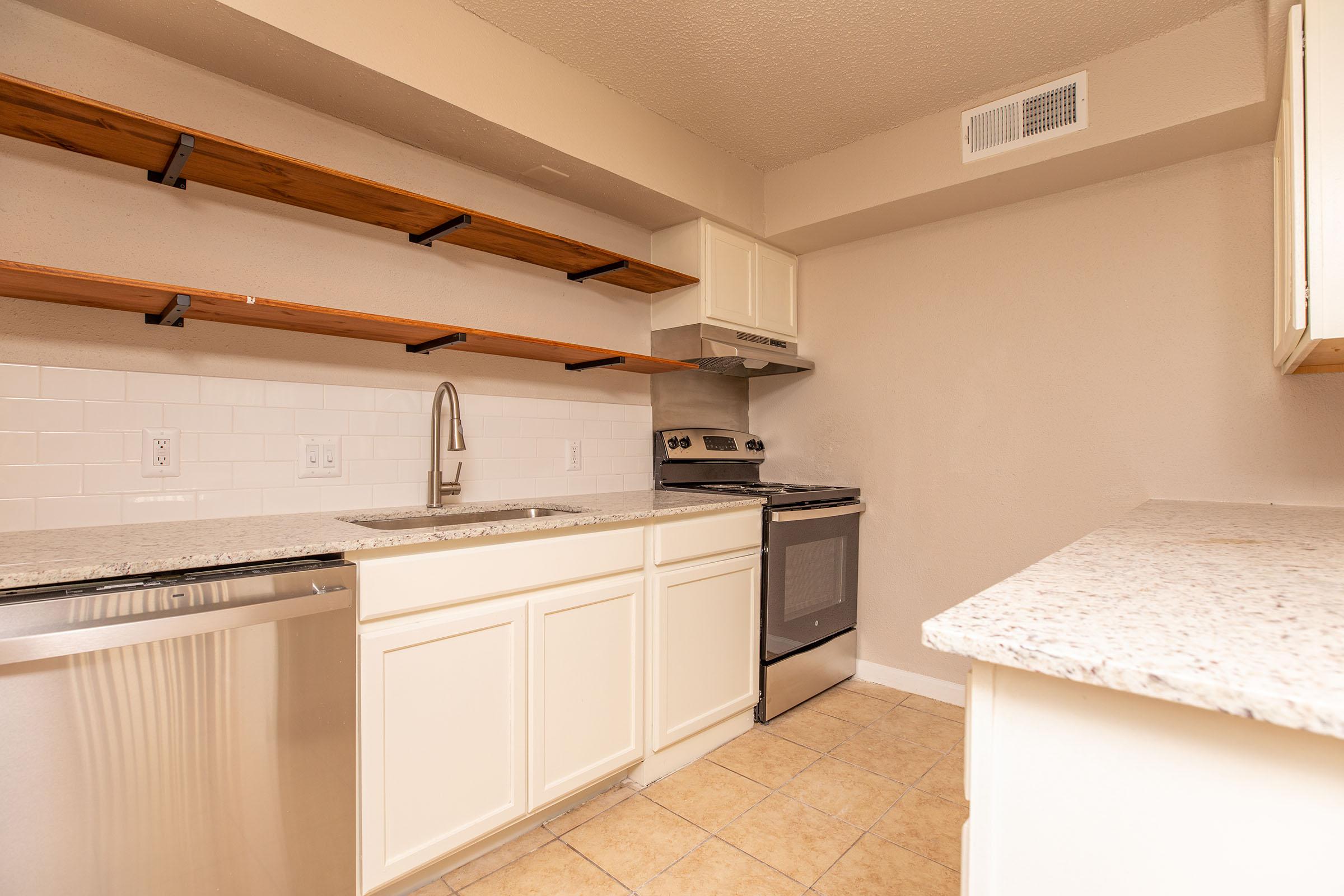 a kitchen with a stove and a sink