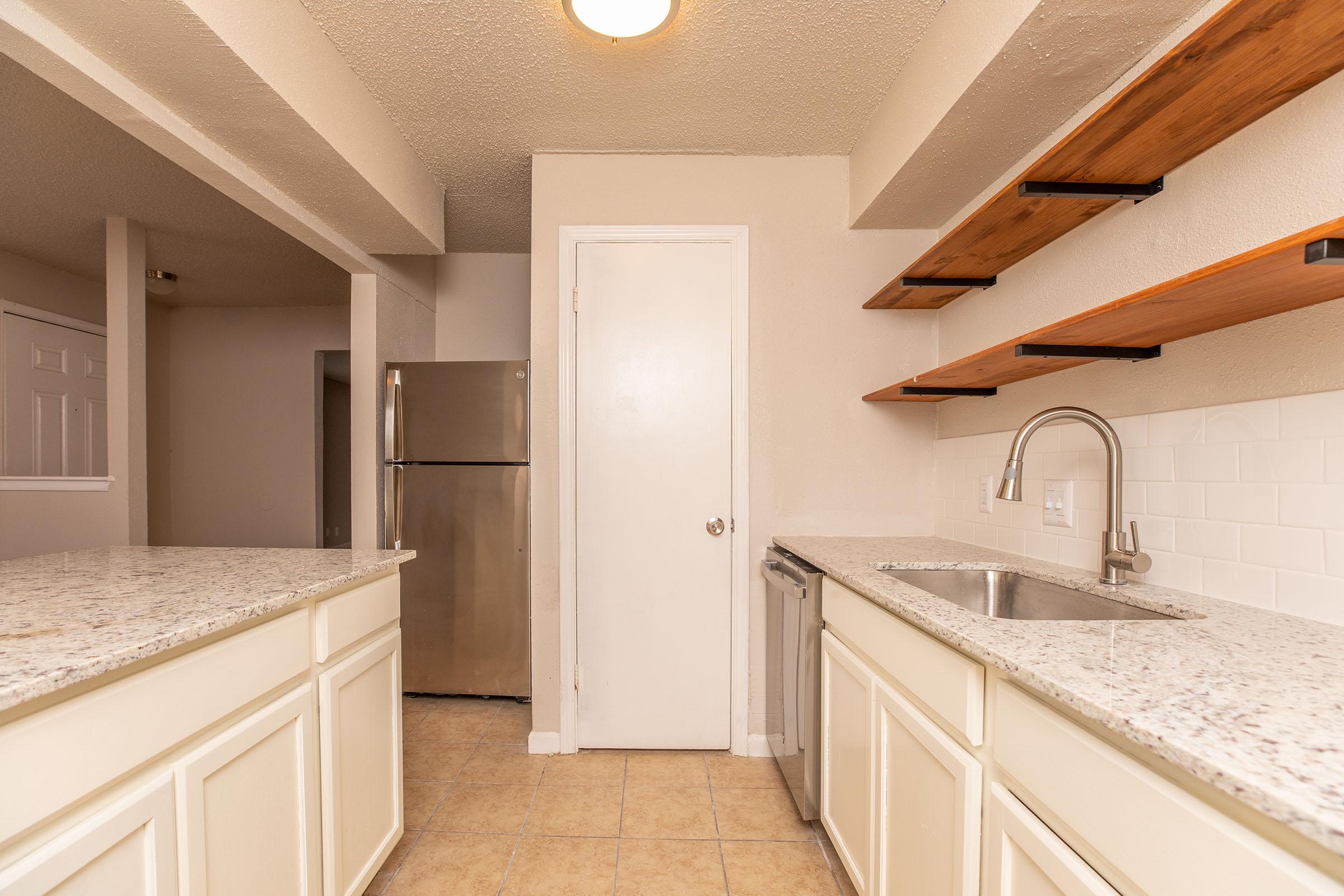 a kitchen with a sink and a mirror