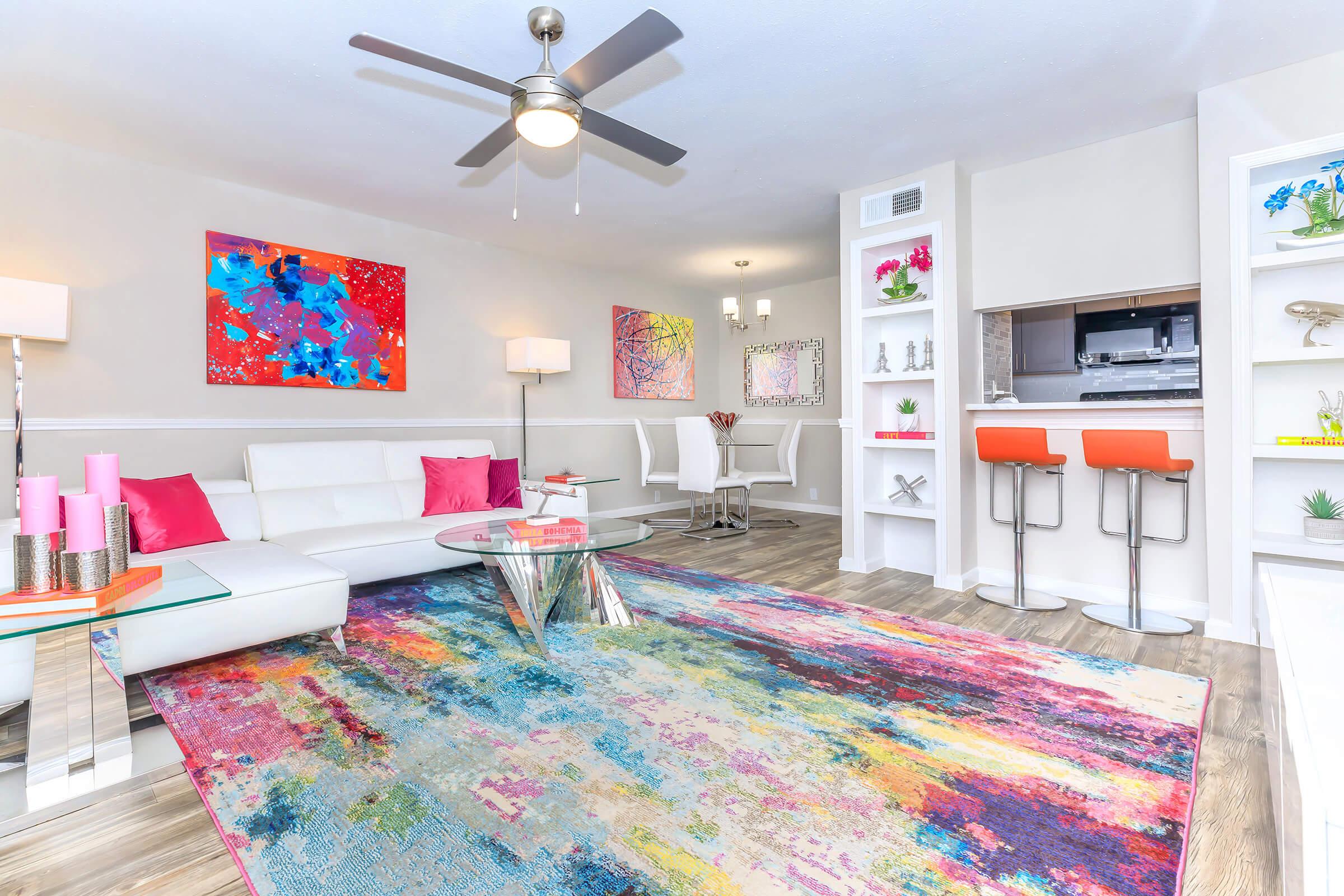 a living room filled with furniture and a rug