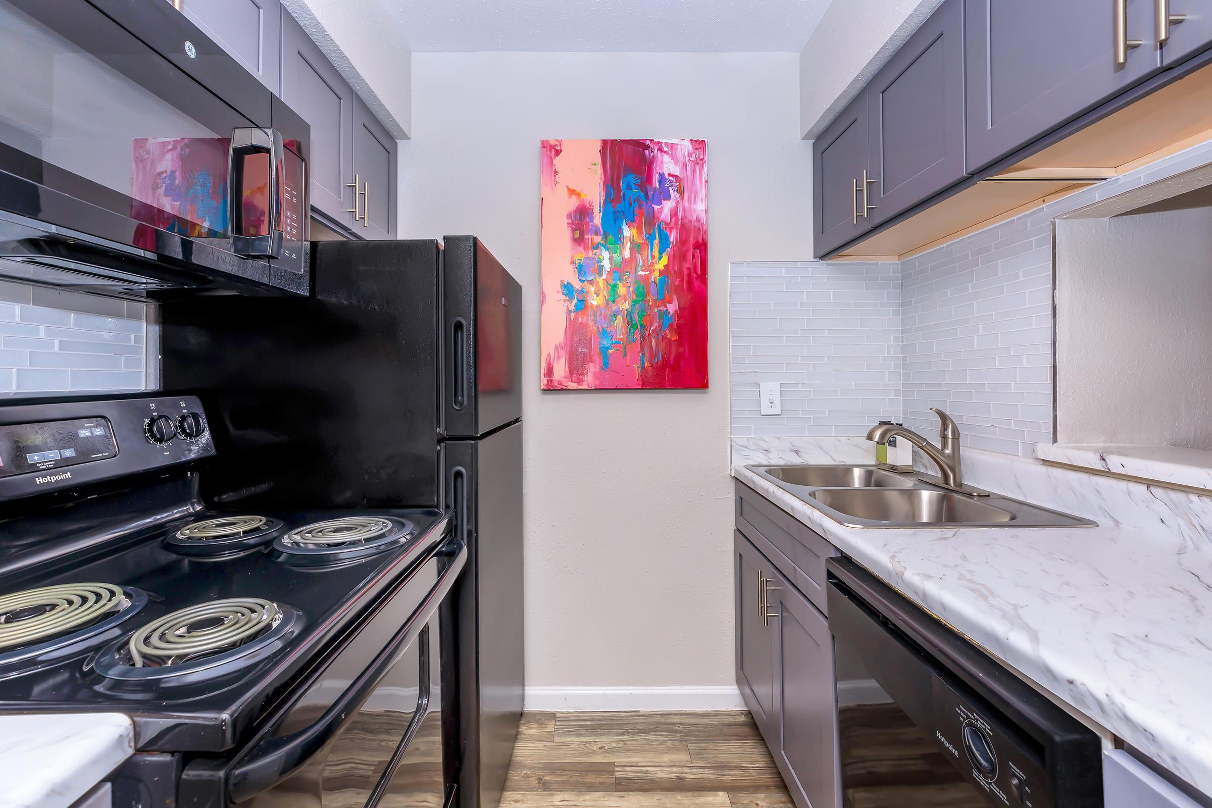 a stove top oven sitting inside of a kitchen