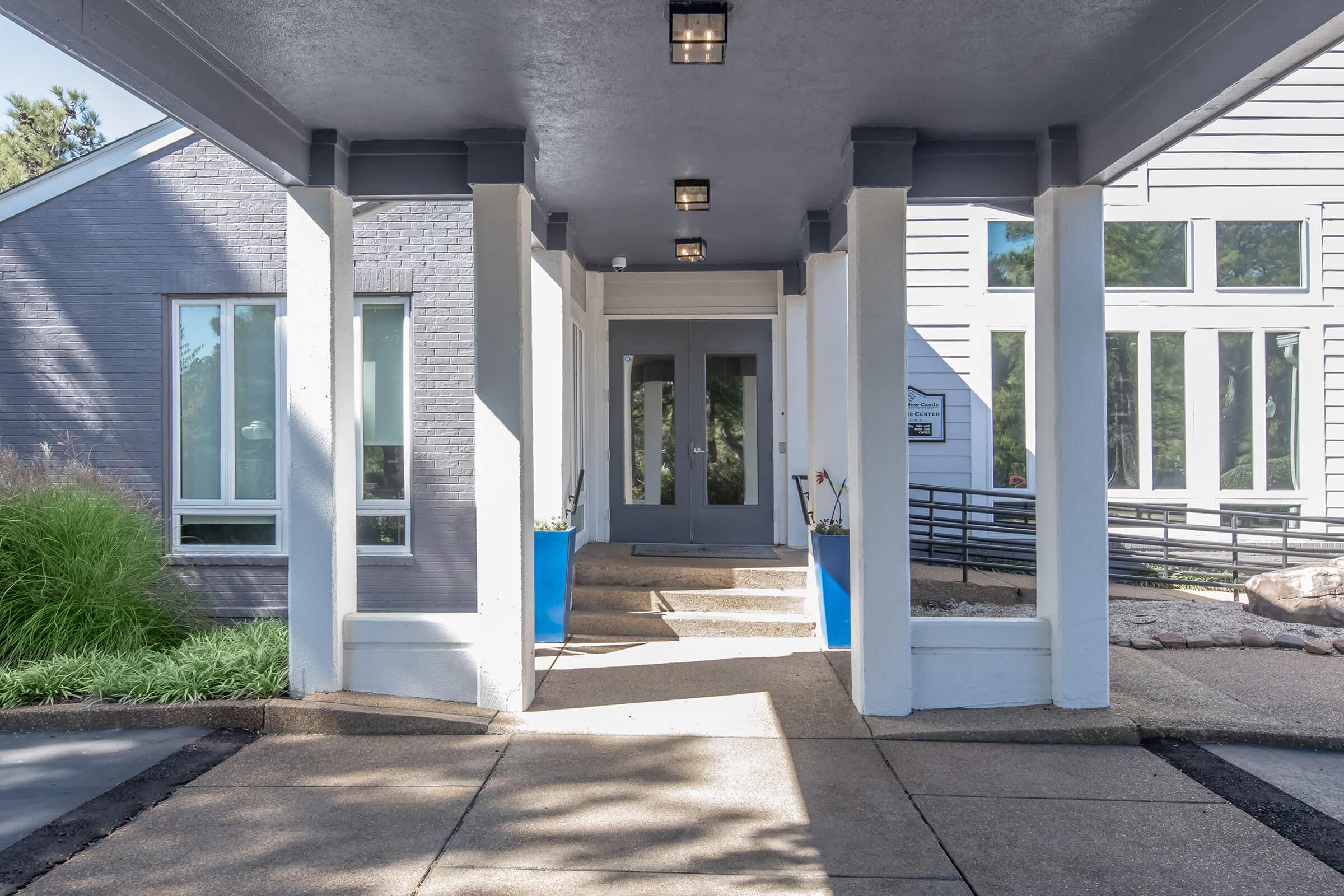 an empty sidewalk in front of a building