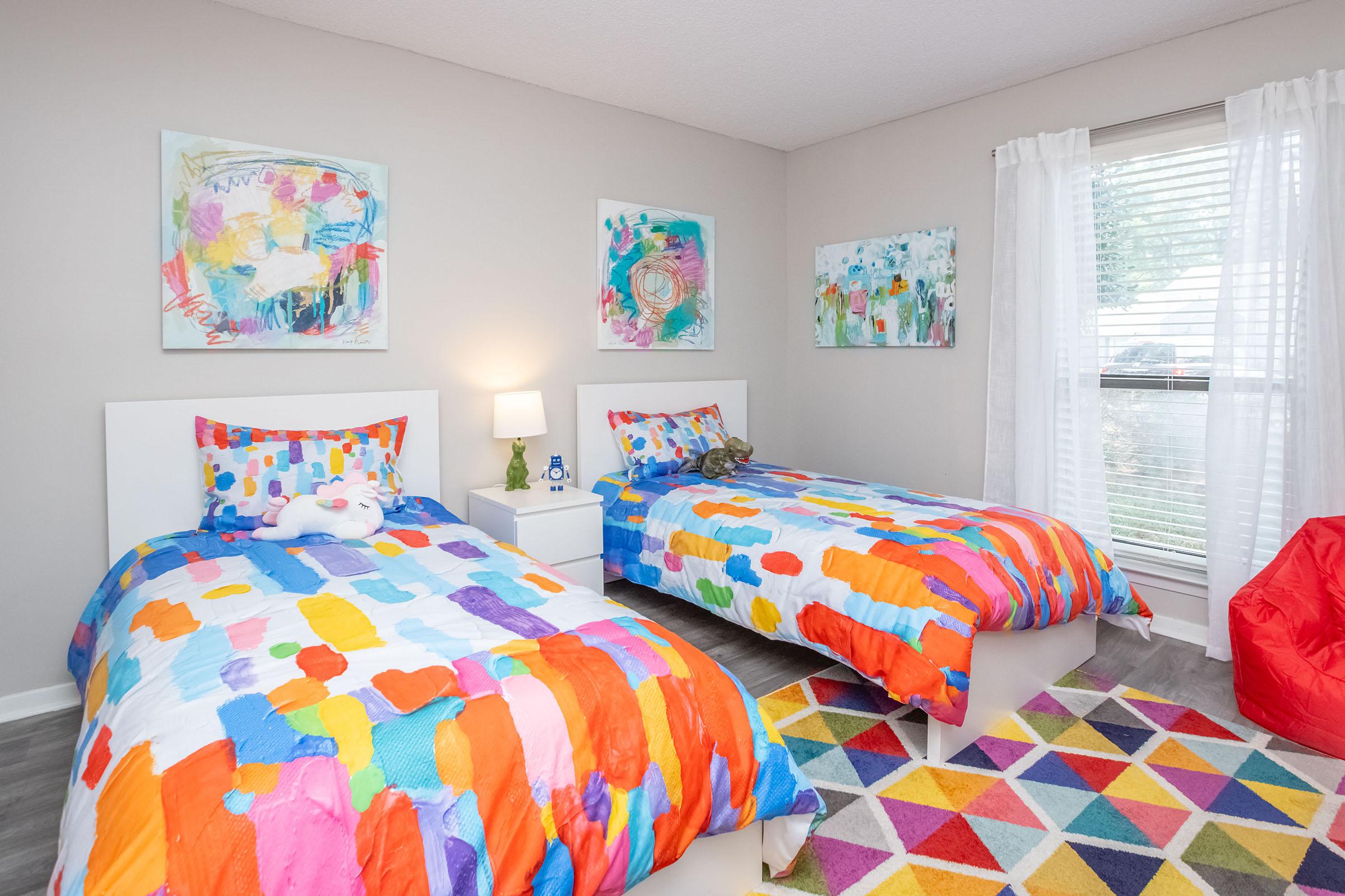 a bedroom with a colorful blanket