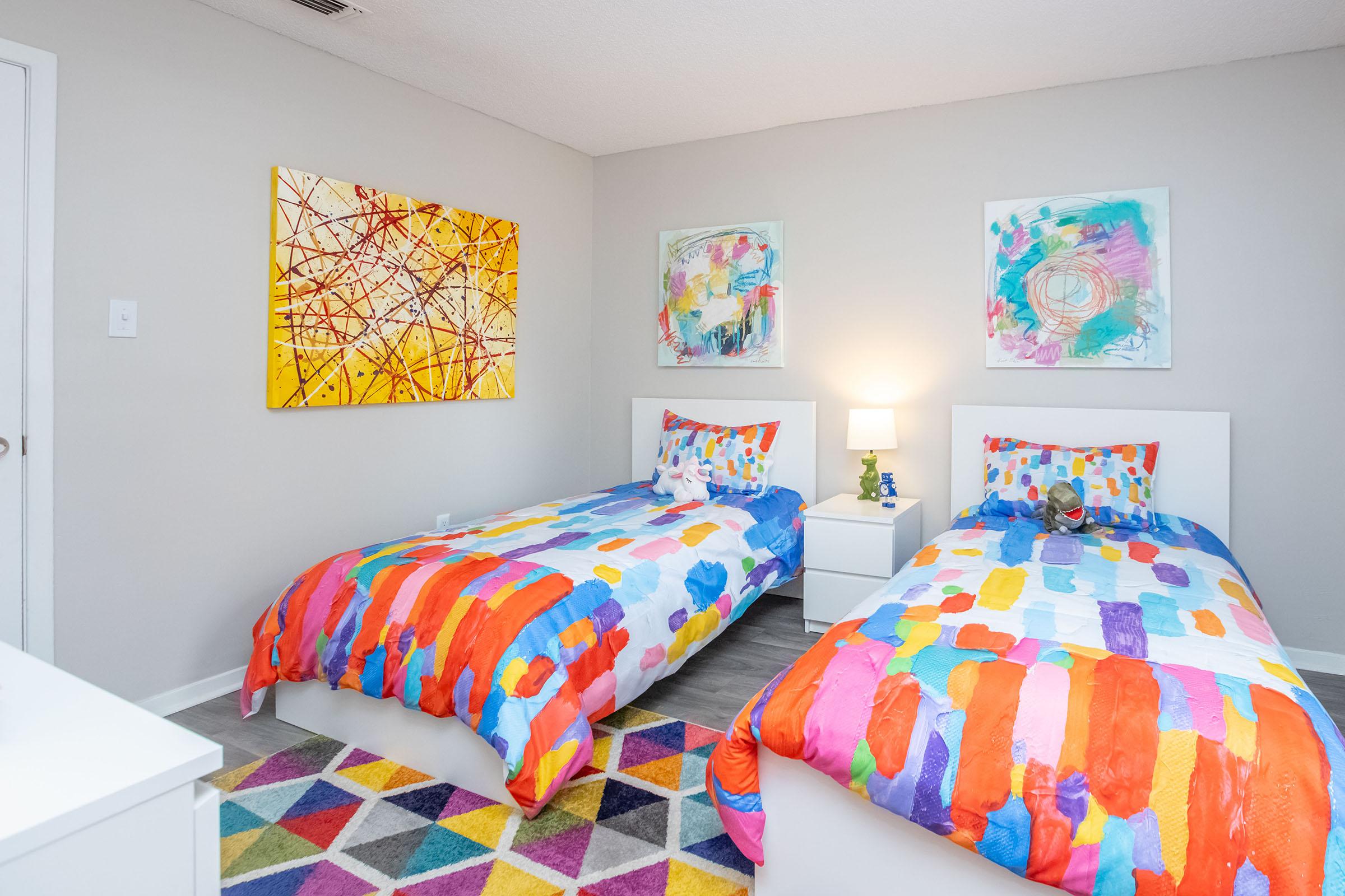 a bedroom with a colorful blanket