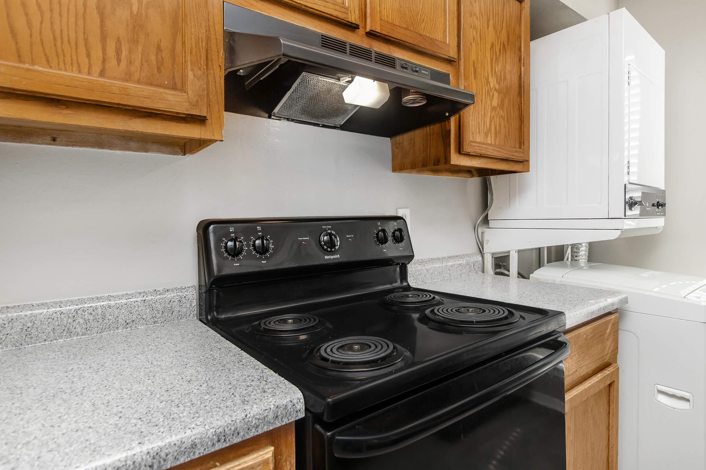 a stove top oven sitting inside of a kitchen