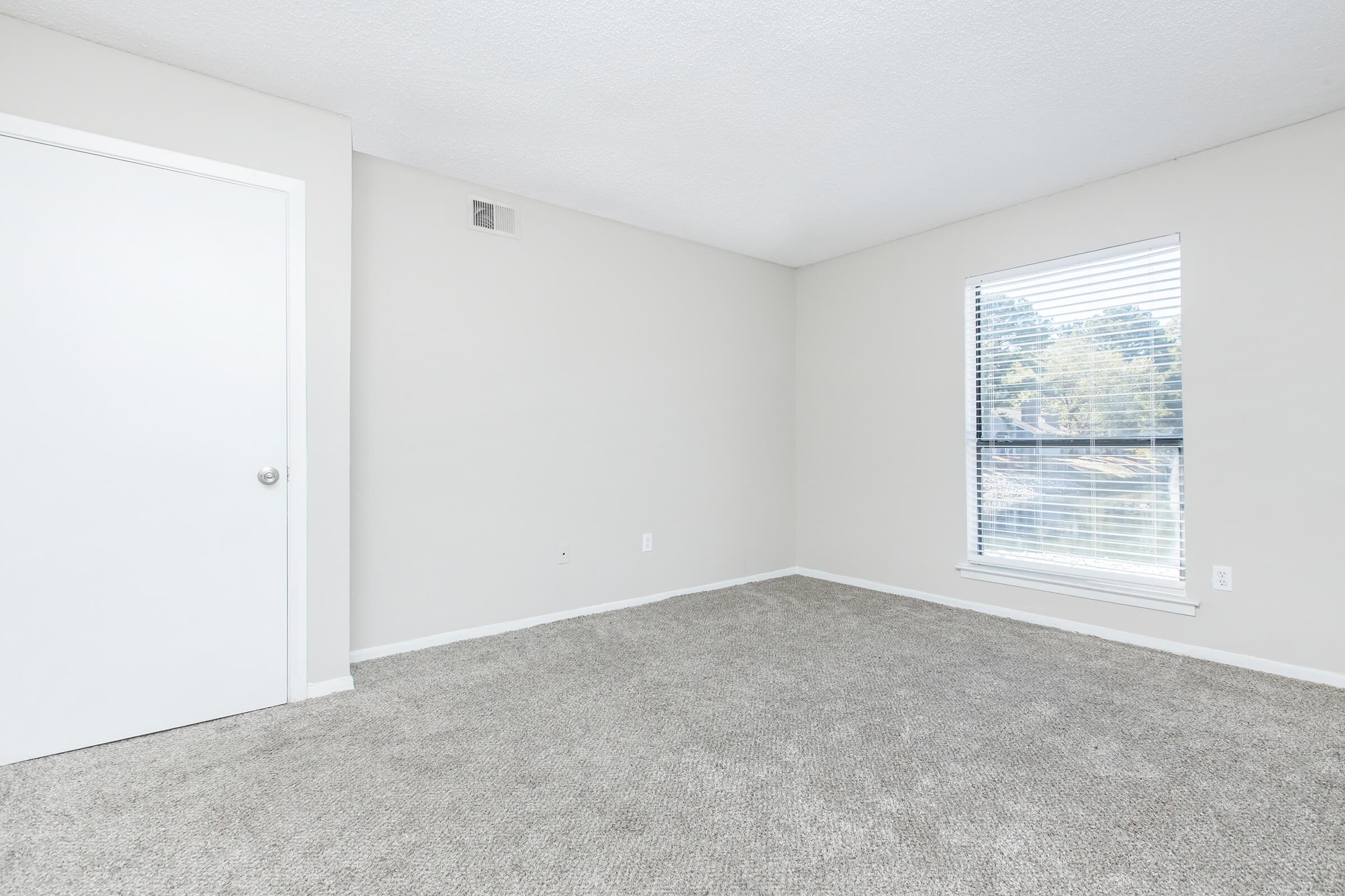 a view of a bedroom next to a window