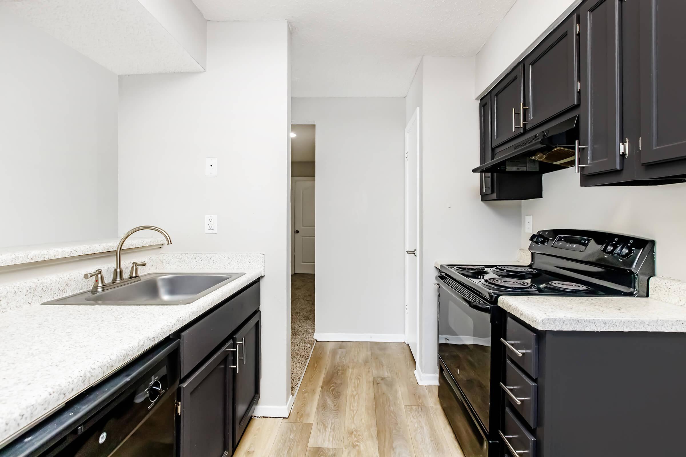 a kitchen with a stove sink and refrigerator