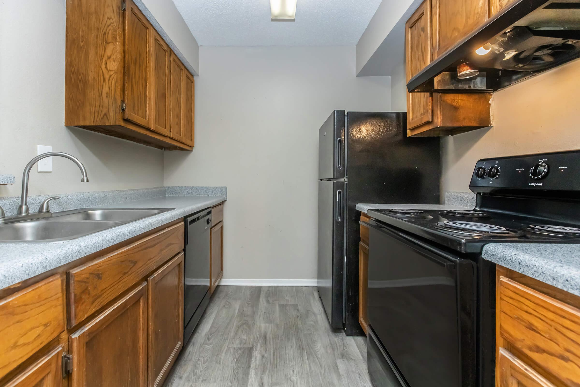 a kitchen with stainless steel appliances and wooden cabinets