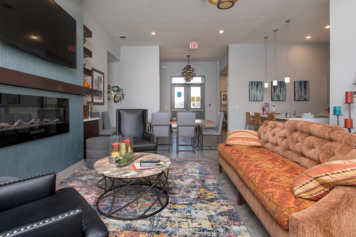 a living room filled with furniture and a flat screen tv