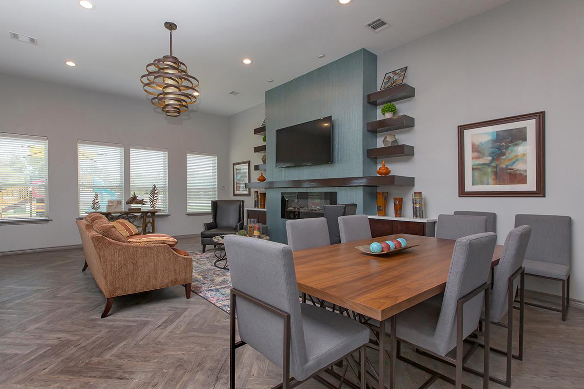 a living area with a desk and chair in a room