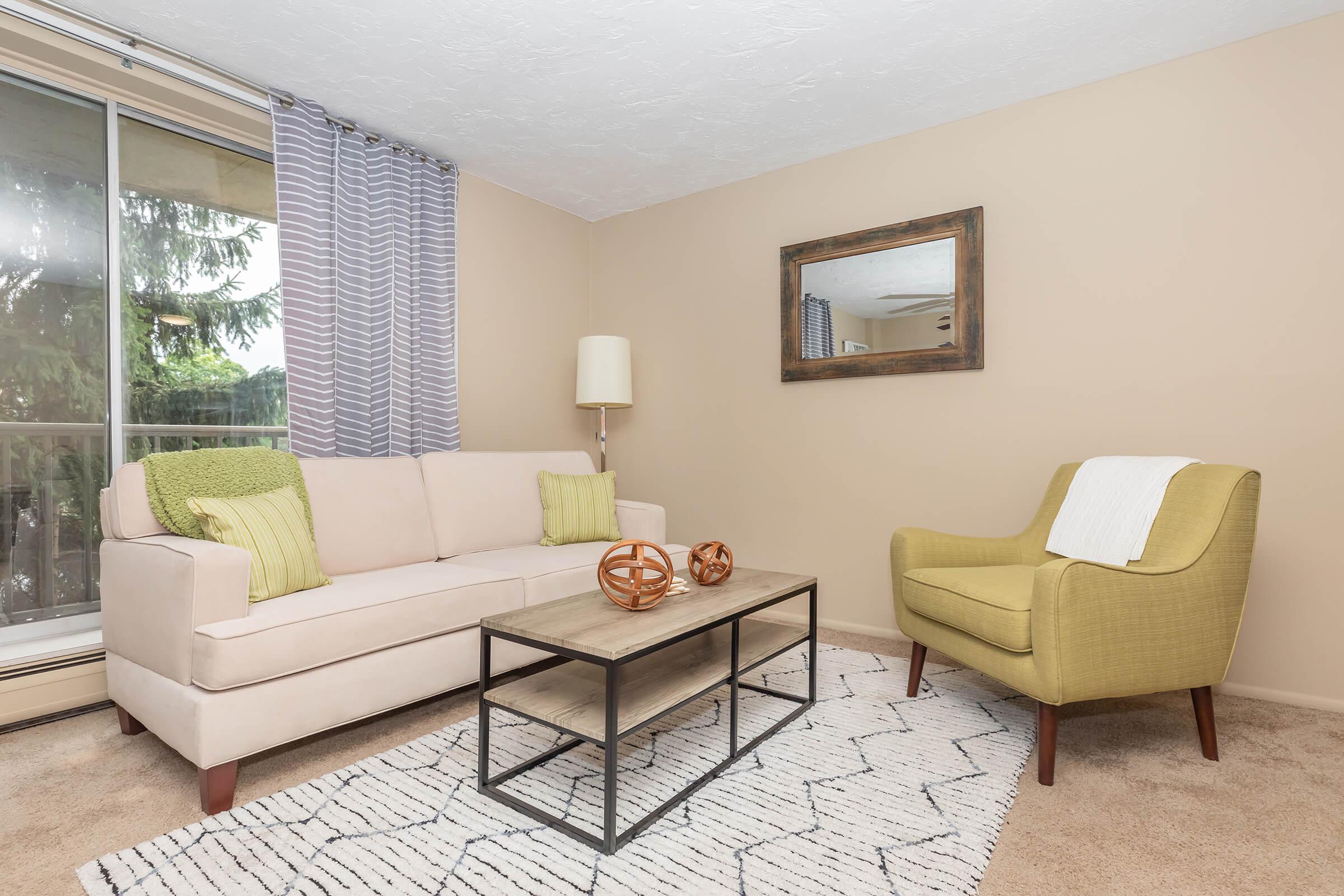 a living room filled with furniture and a flat screen tv