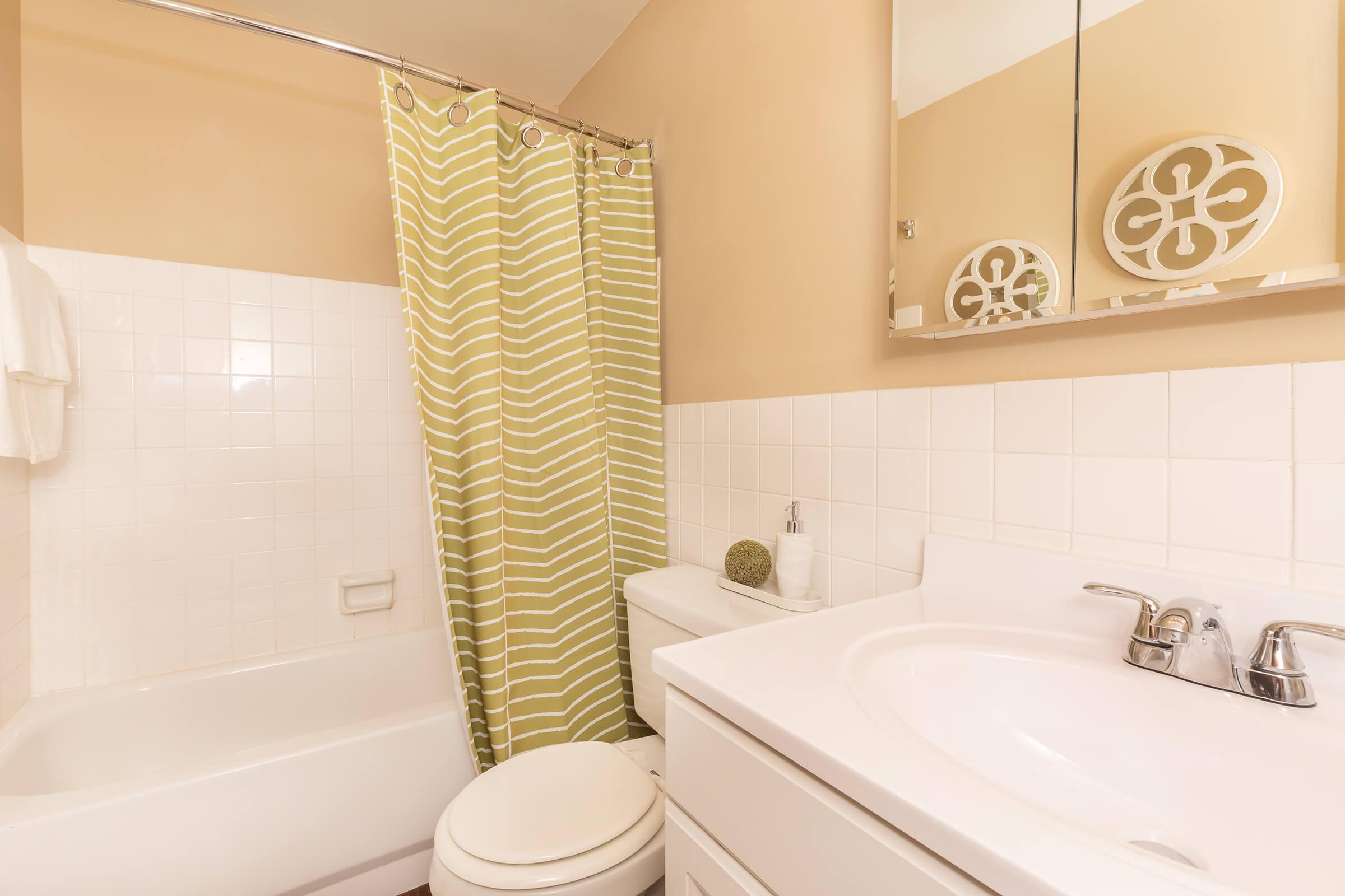 a white tub sitting next to a sink