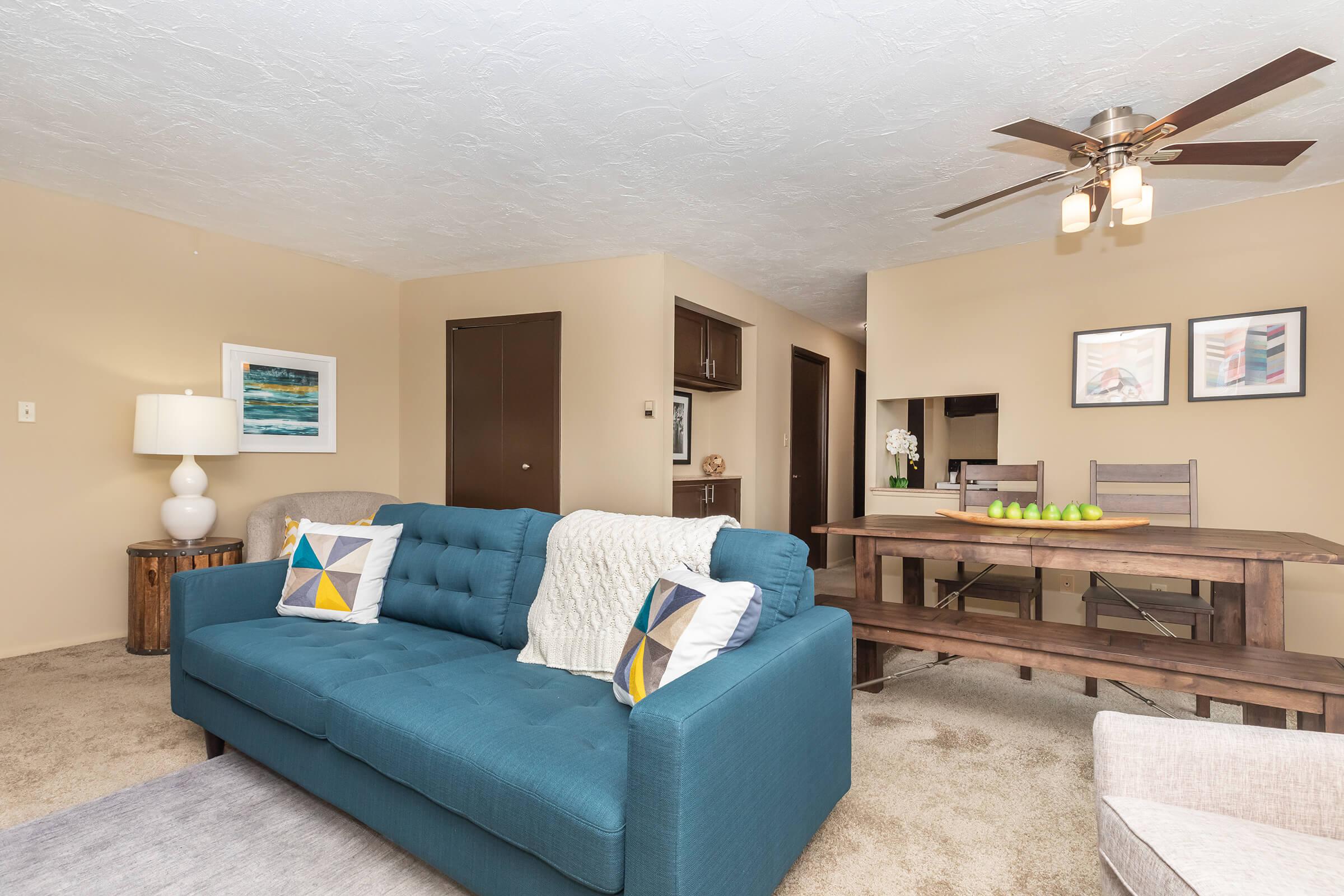a living room filled with furniture and a tv