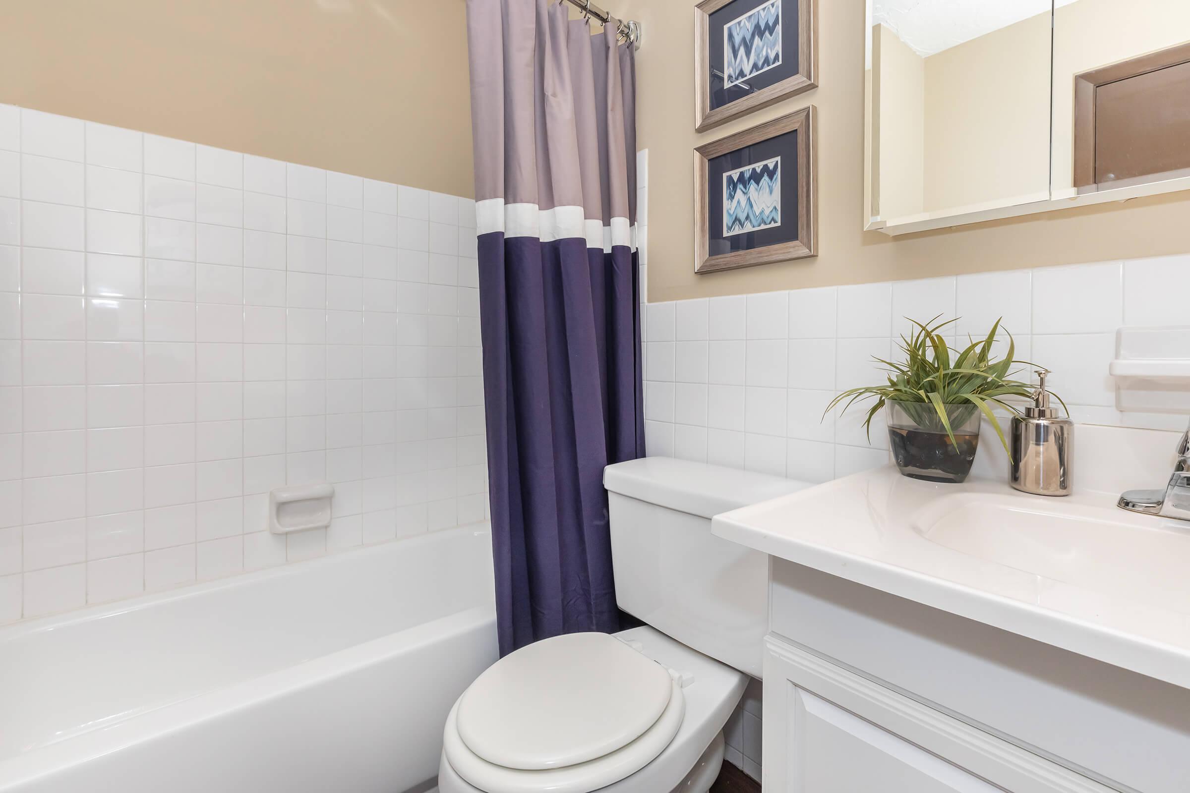 a white tub sitting next to a sink