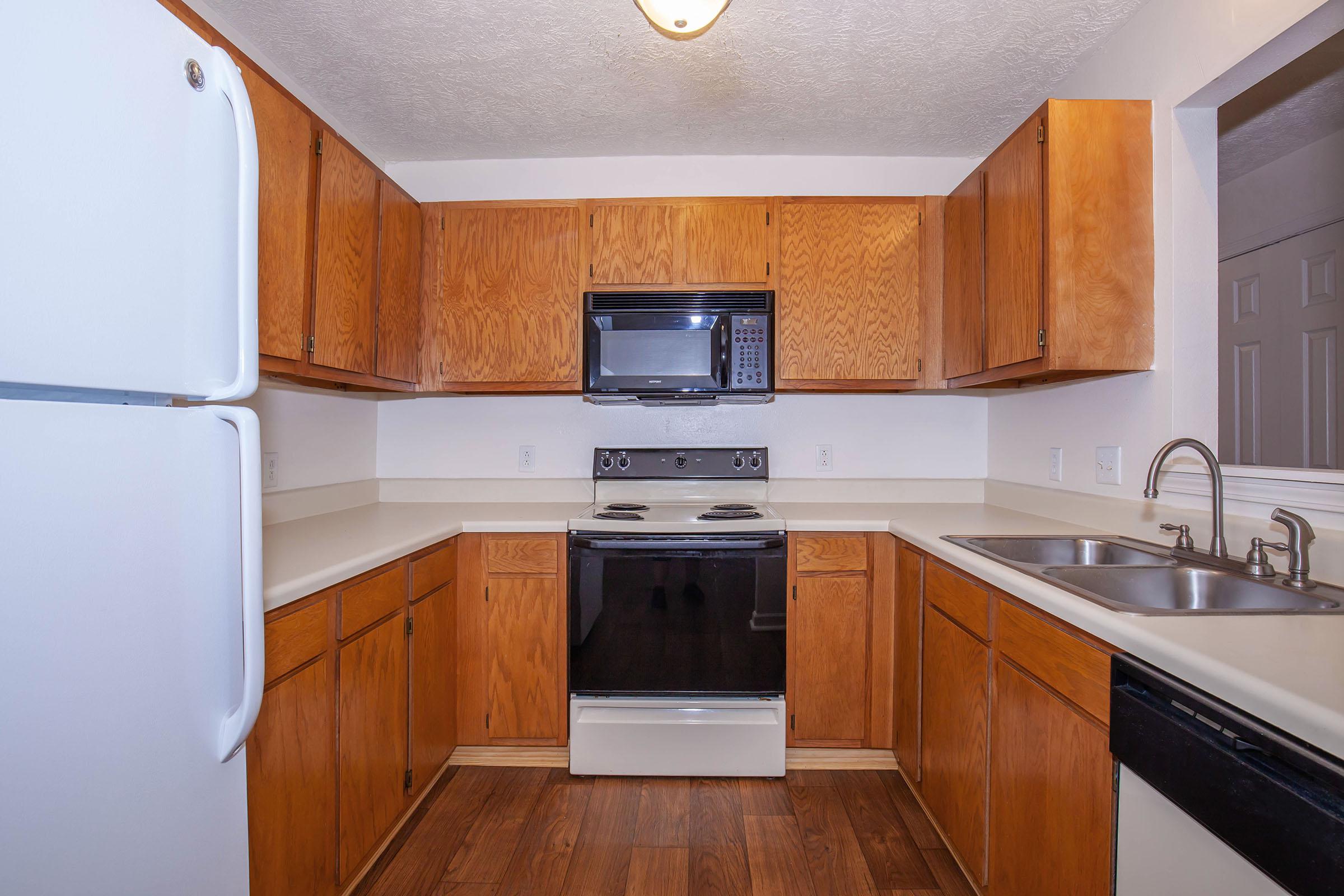 a kitchen with a stove top oven sitting inside of a refrigerator