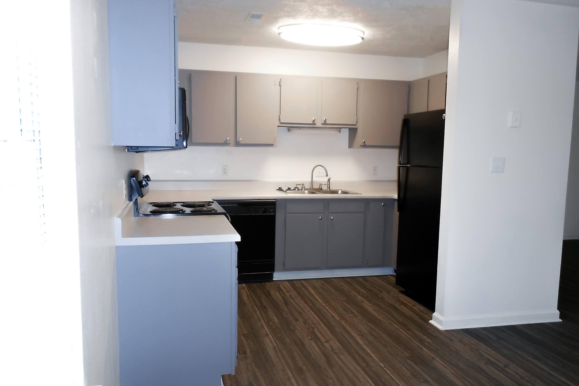 a kitchen with a sink and a refrigerator