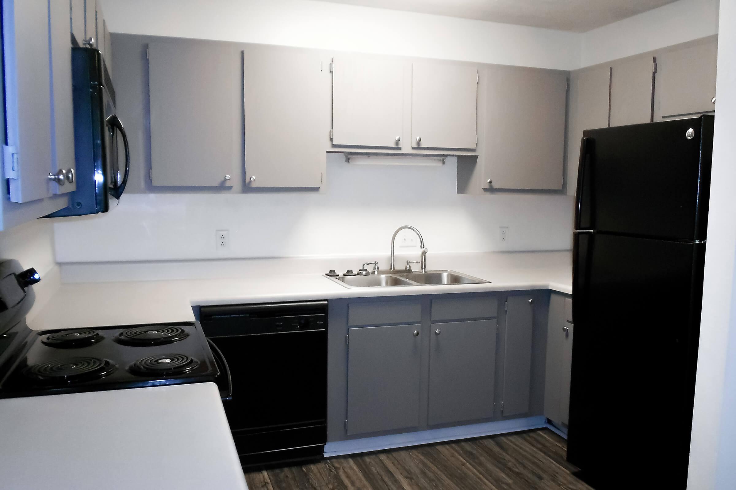 a kitchen with a stove and a refrigerator